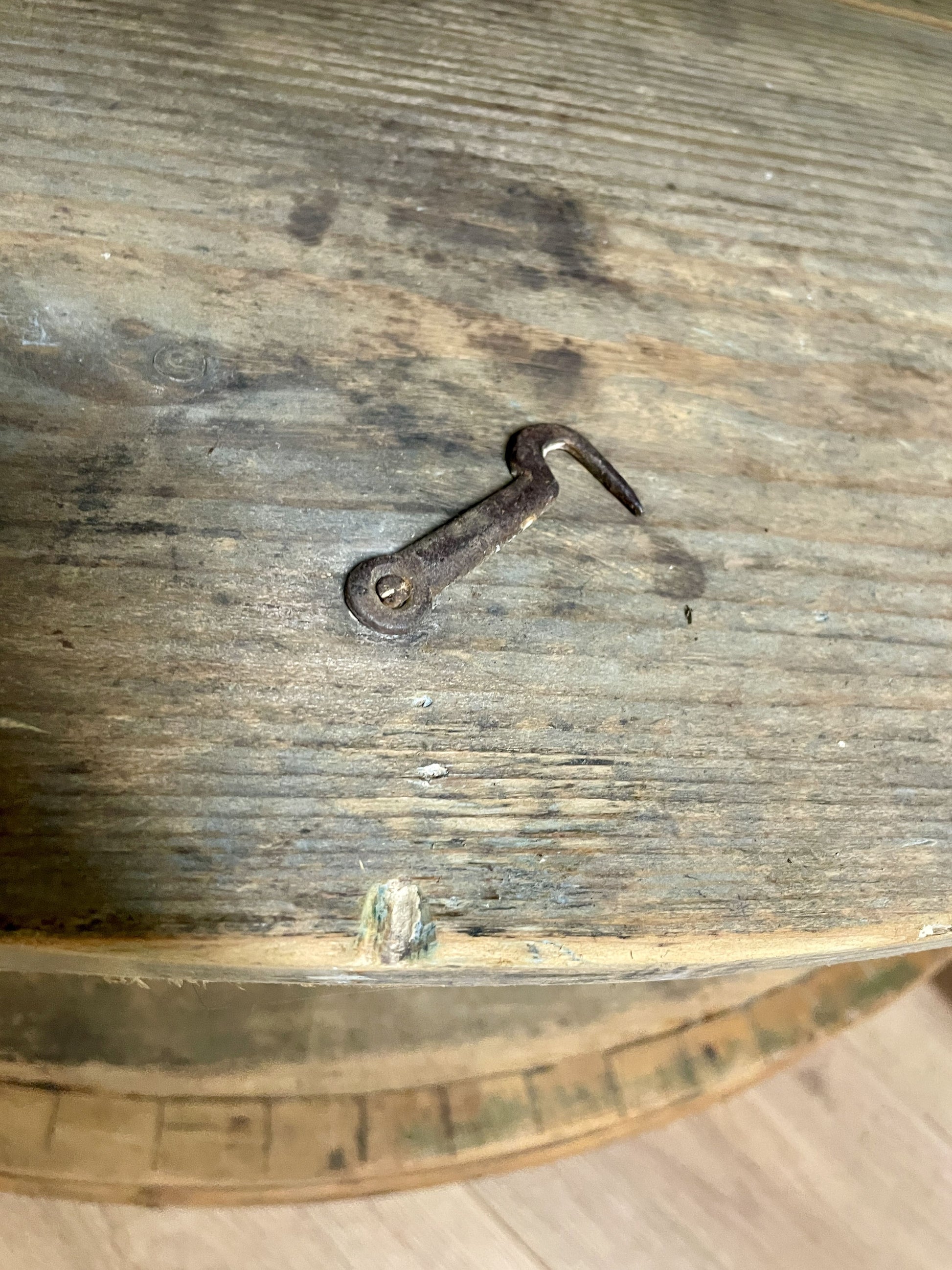 Rustic wooden surface with a metal hook embedded in it