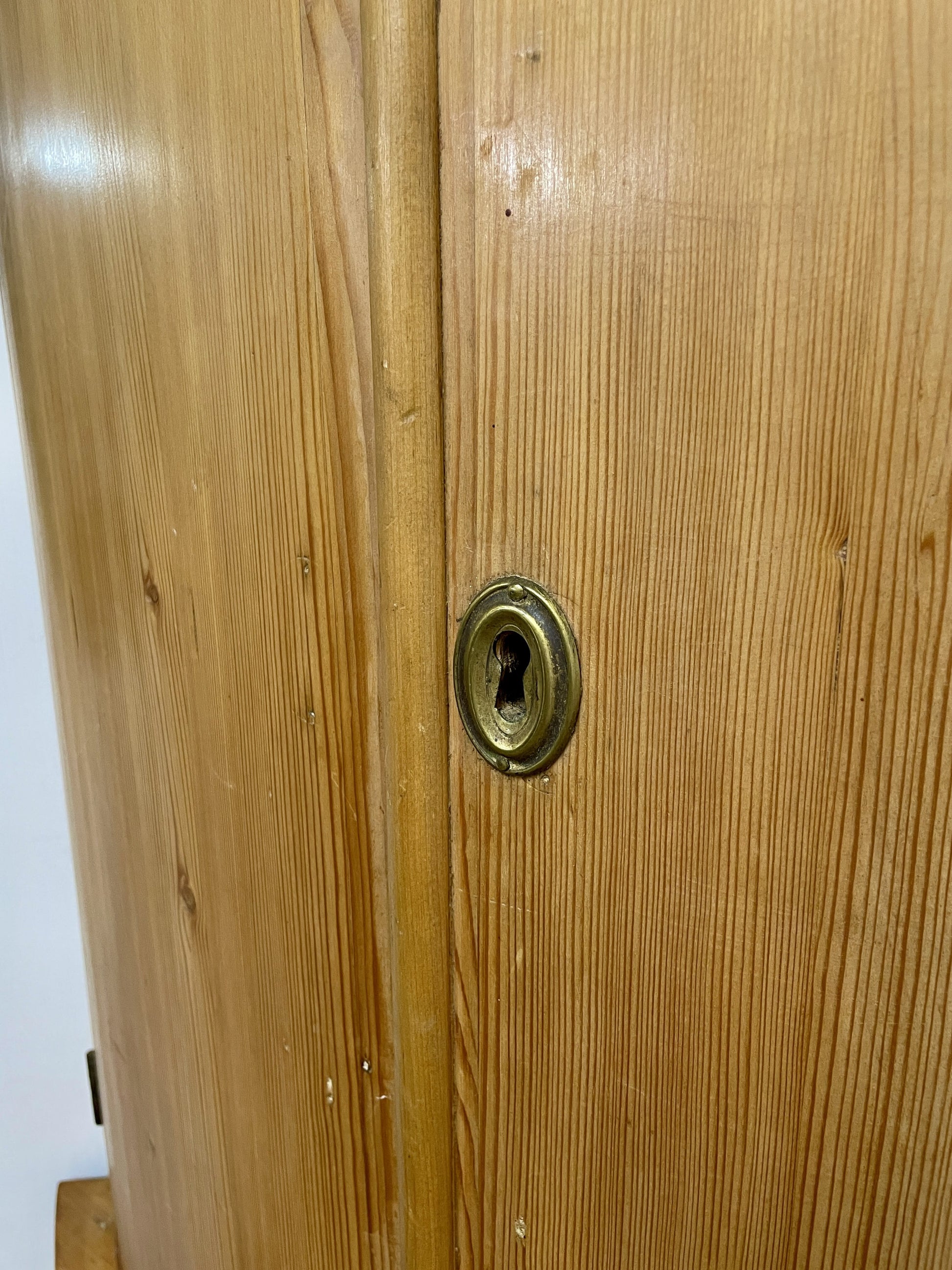 Wooden door with a brass doorknob and lock