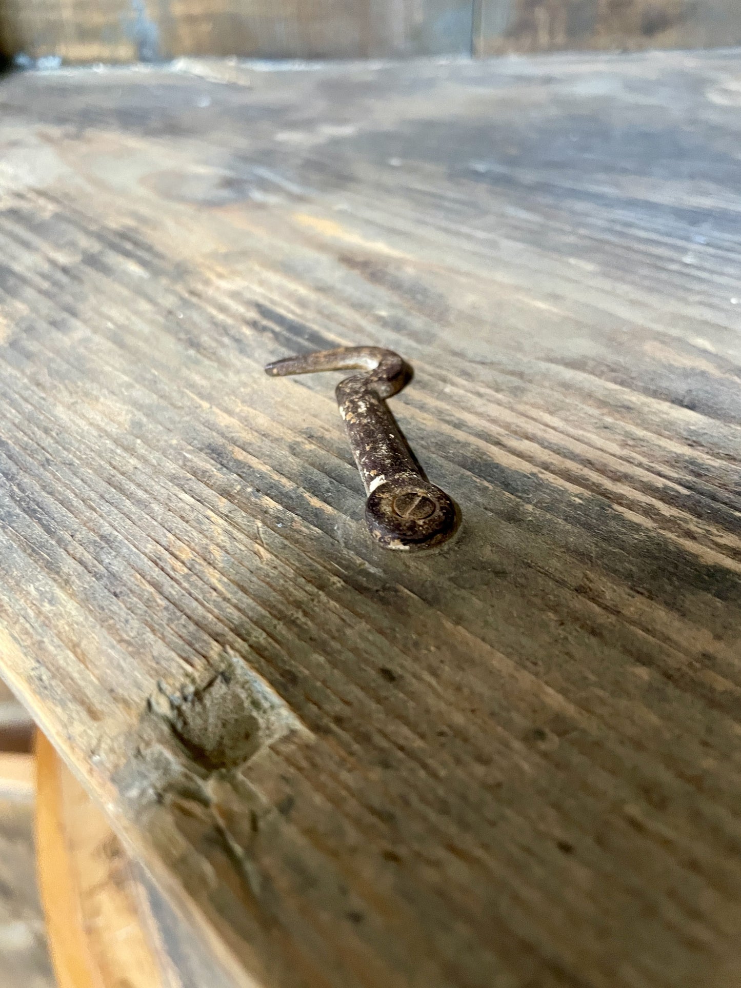 Small metal object on a wooden surface