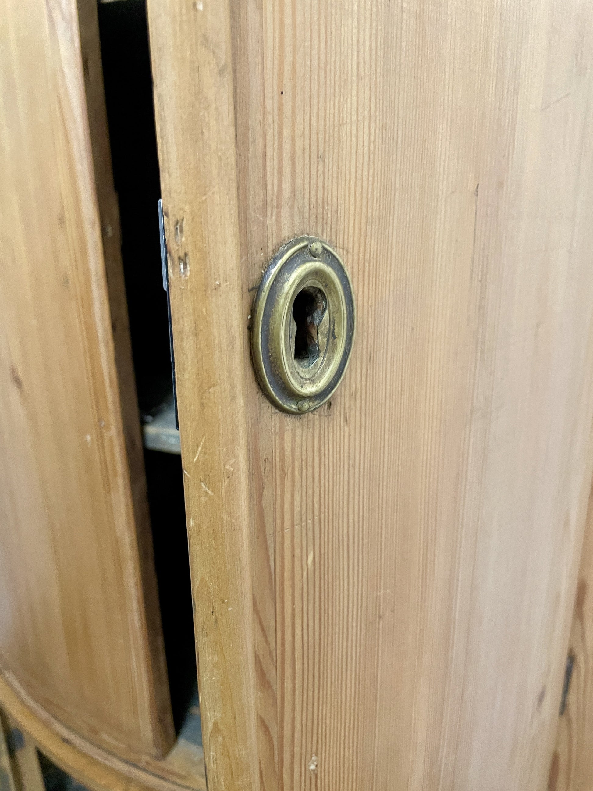 Wooden door with a brass doorknob and lock