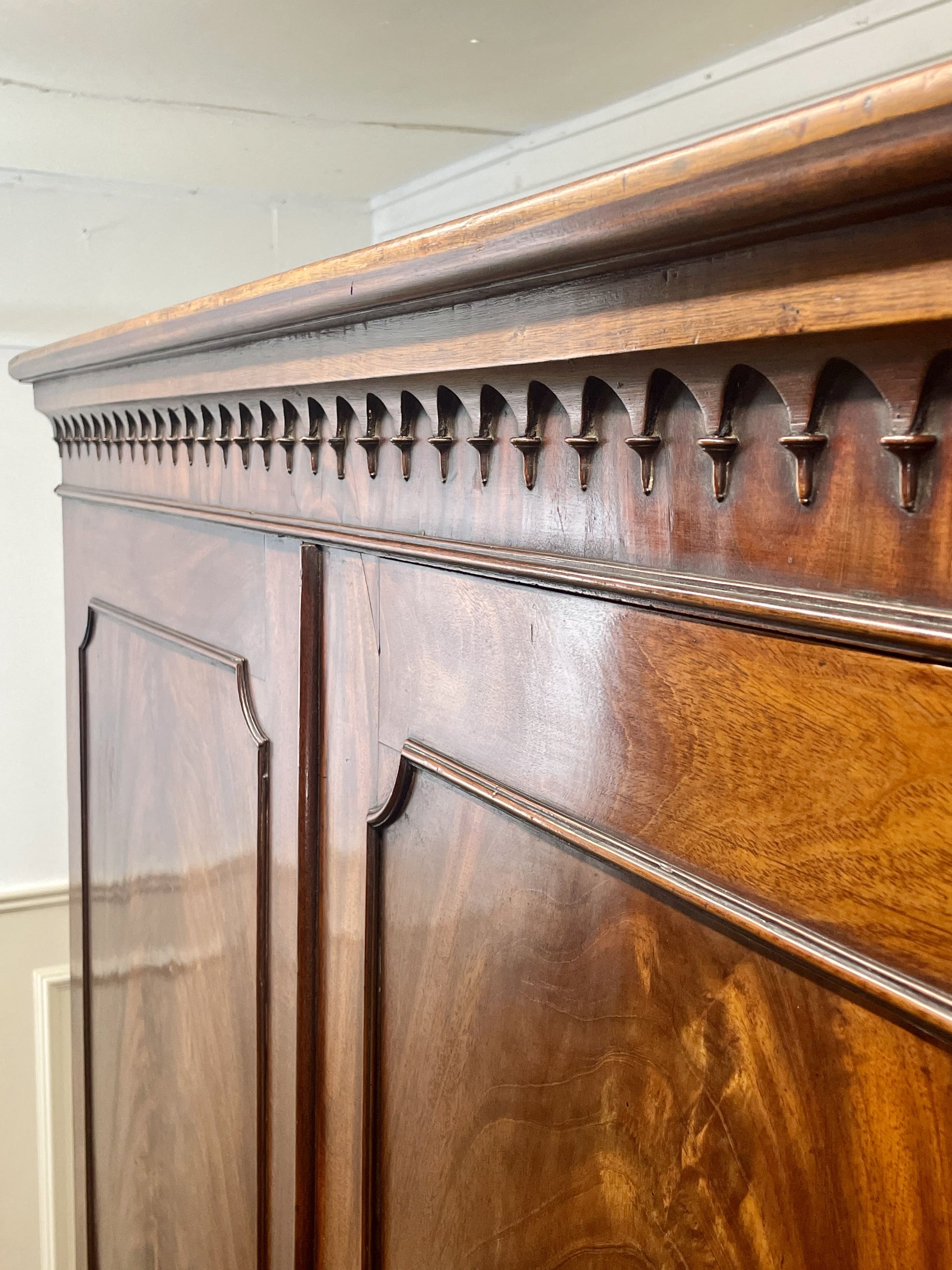Close-up of a wooden cabinet with decorative molding.