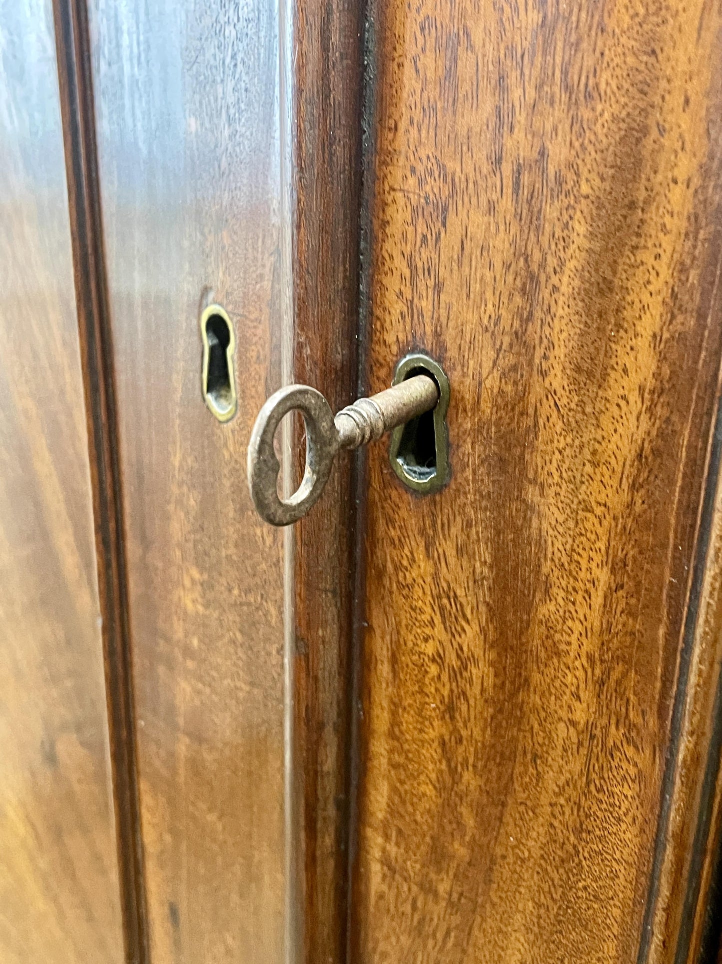 Wooden door with a keyhole and key inserted