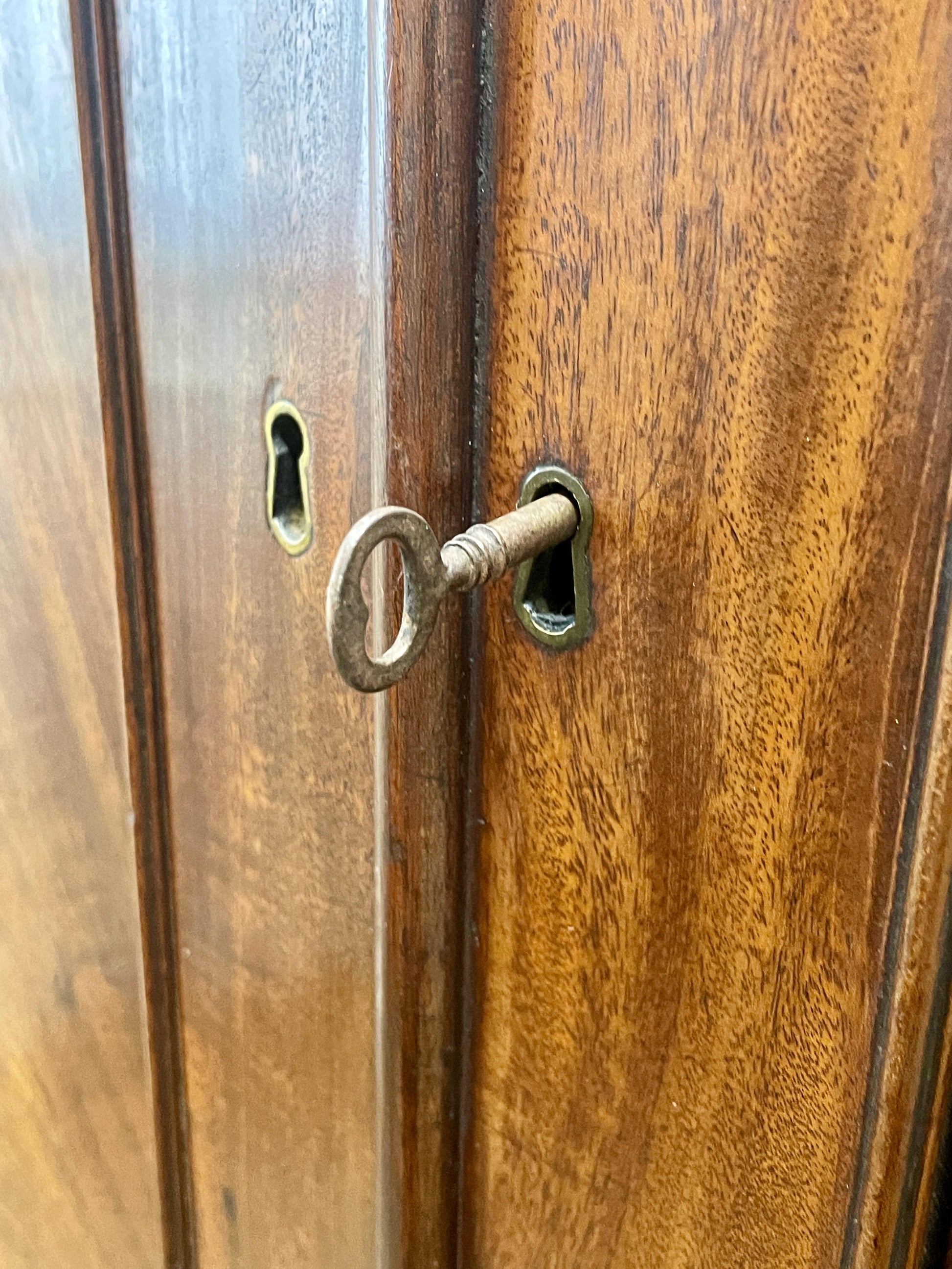 Wooden door with a keyhole and key inserted