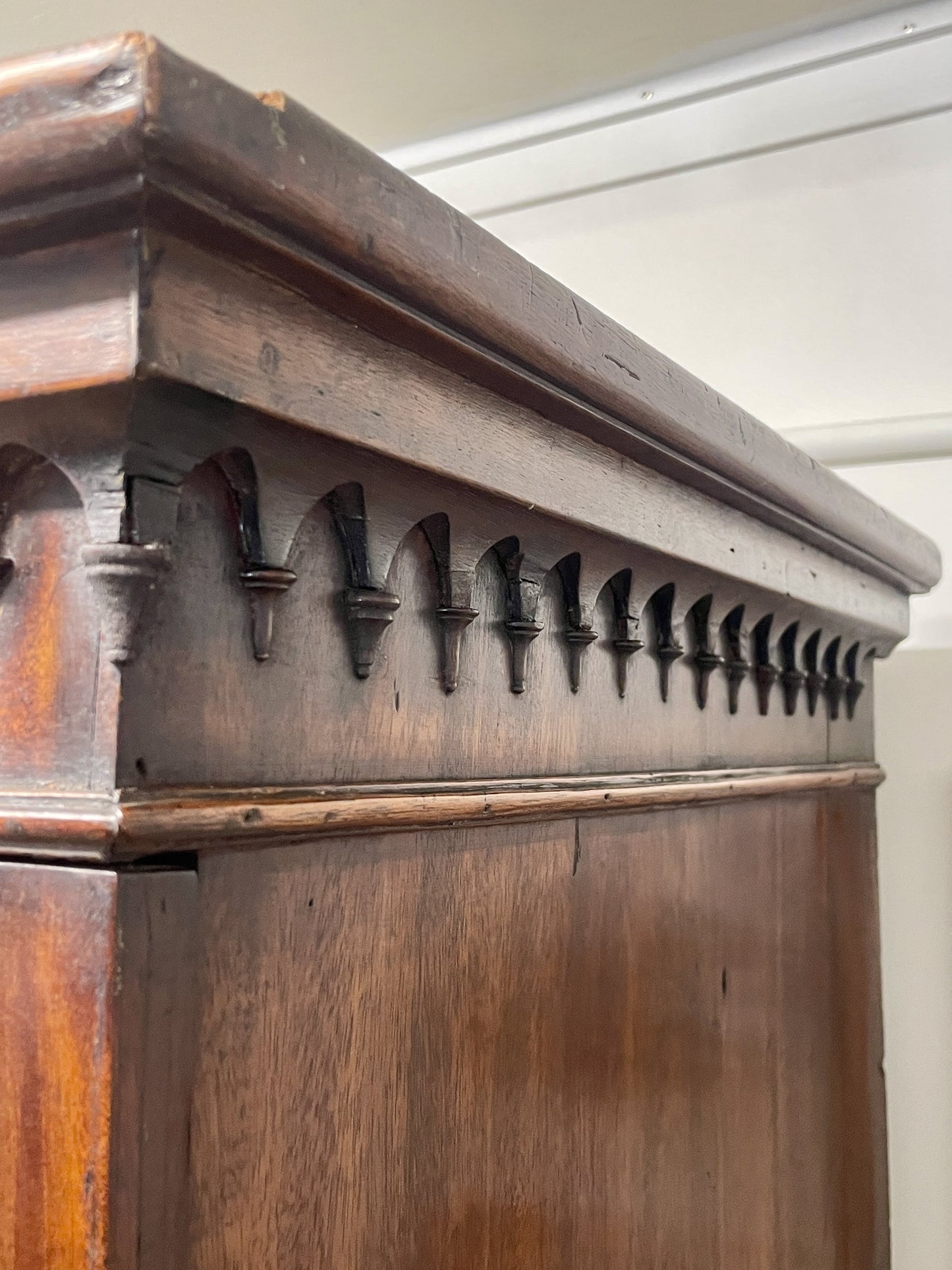 Close-up of an ornate wooden cabinet with decorative carvings.