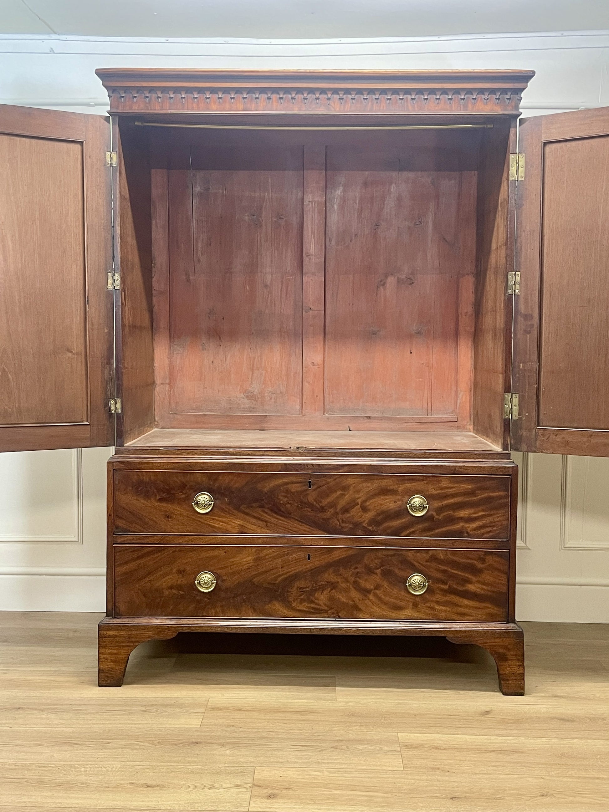 Wooden wardrobe with open doors on a wooden floor