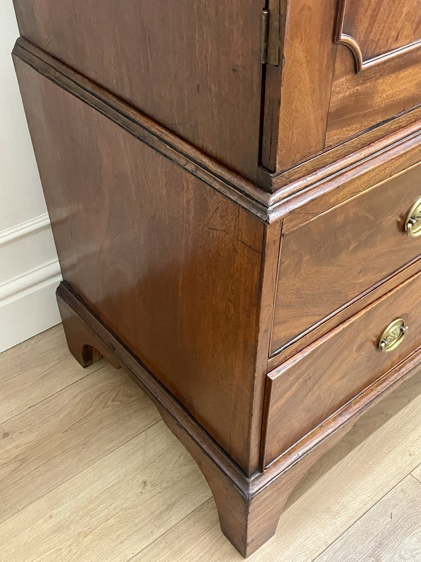 Wooden cabinet with drawers on a light wooden floor