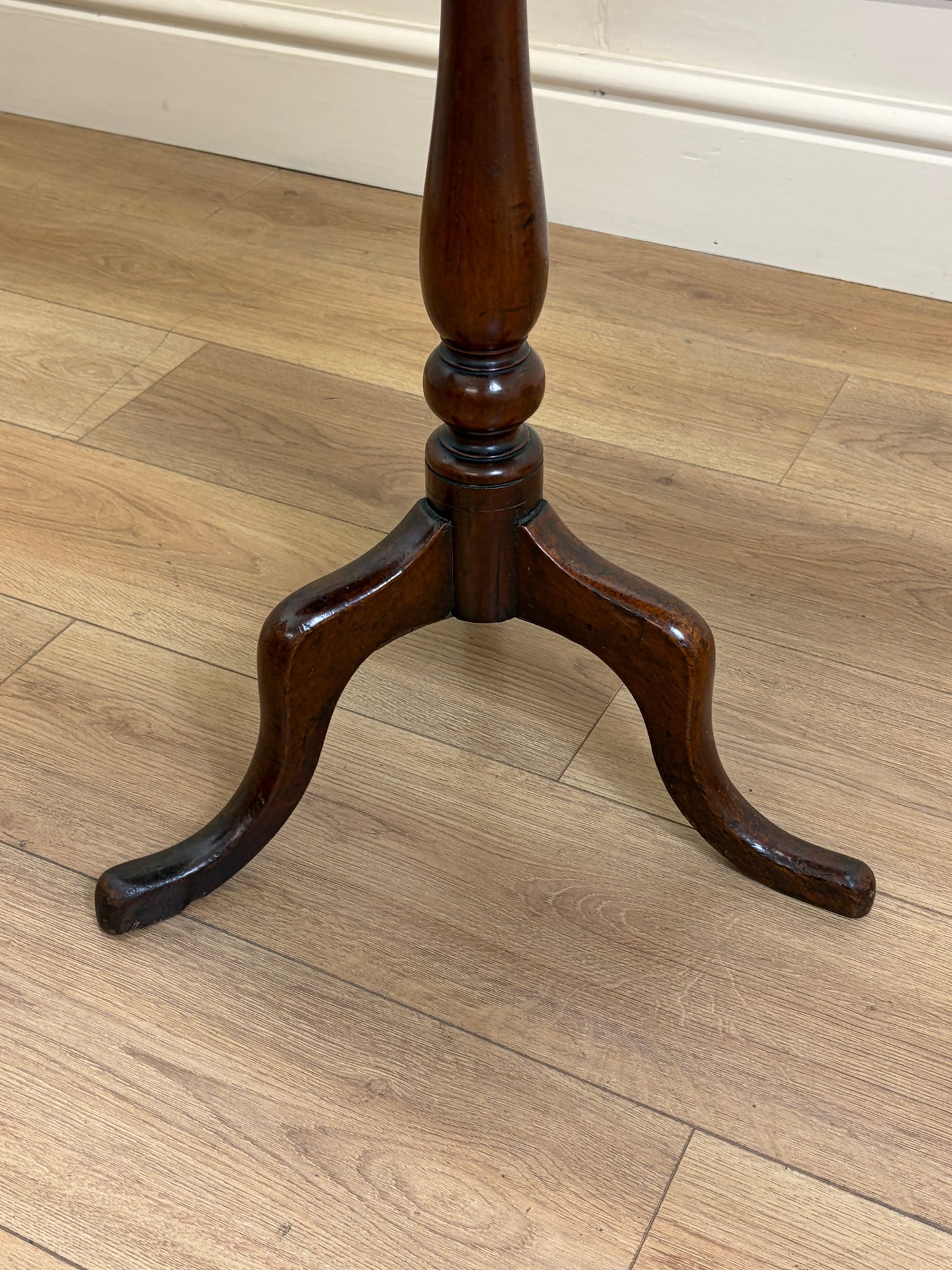 Wooden candlestick on a wooden floor