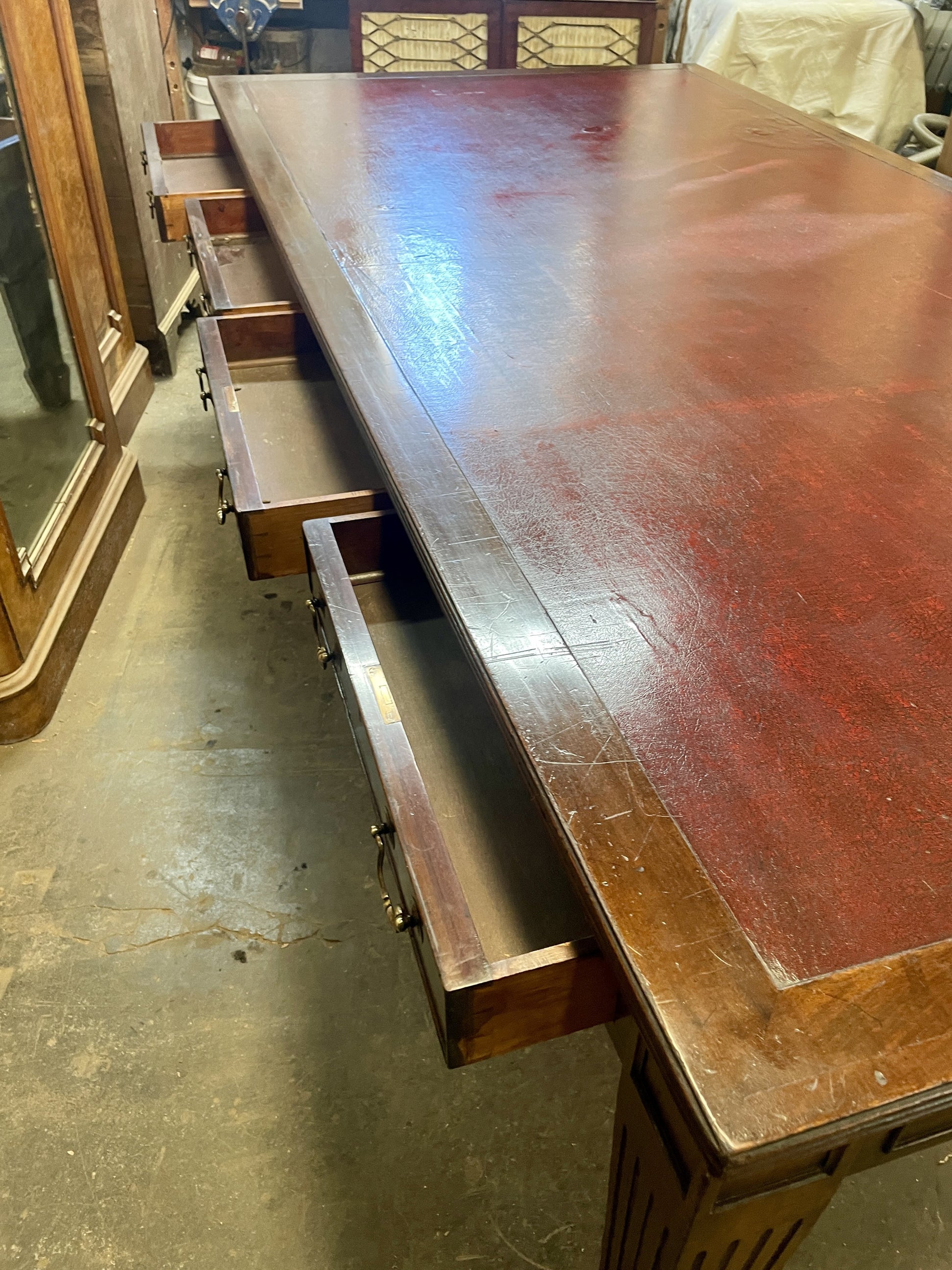 Wooden desk with a drawer in a storage or warehouse setting