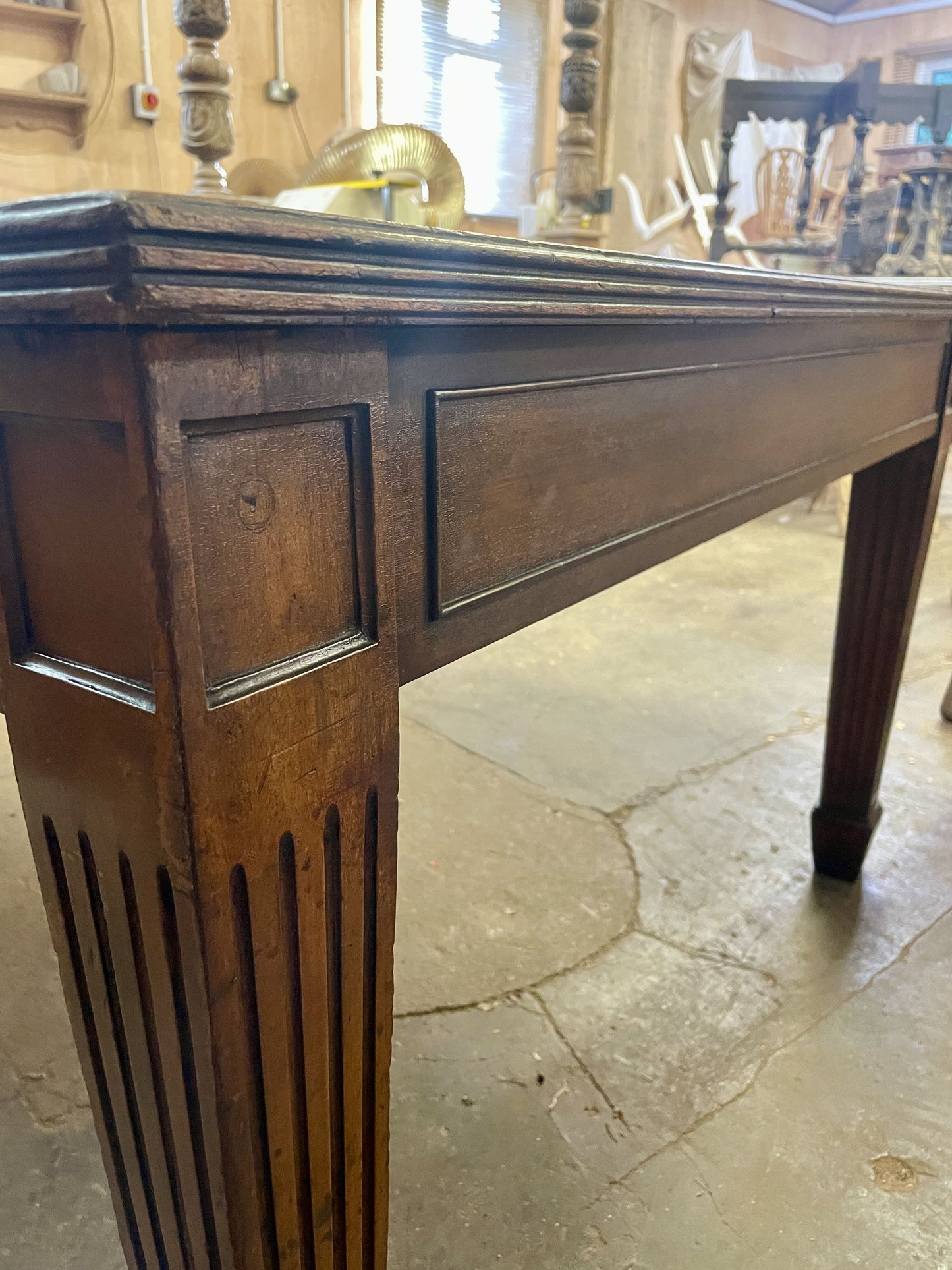 Wooden table with intricate carvings on a stone floor