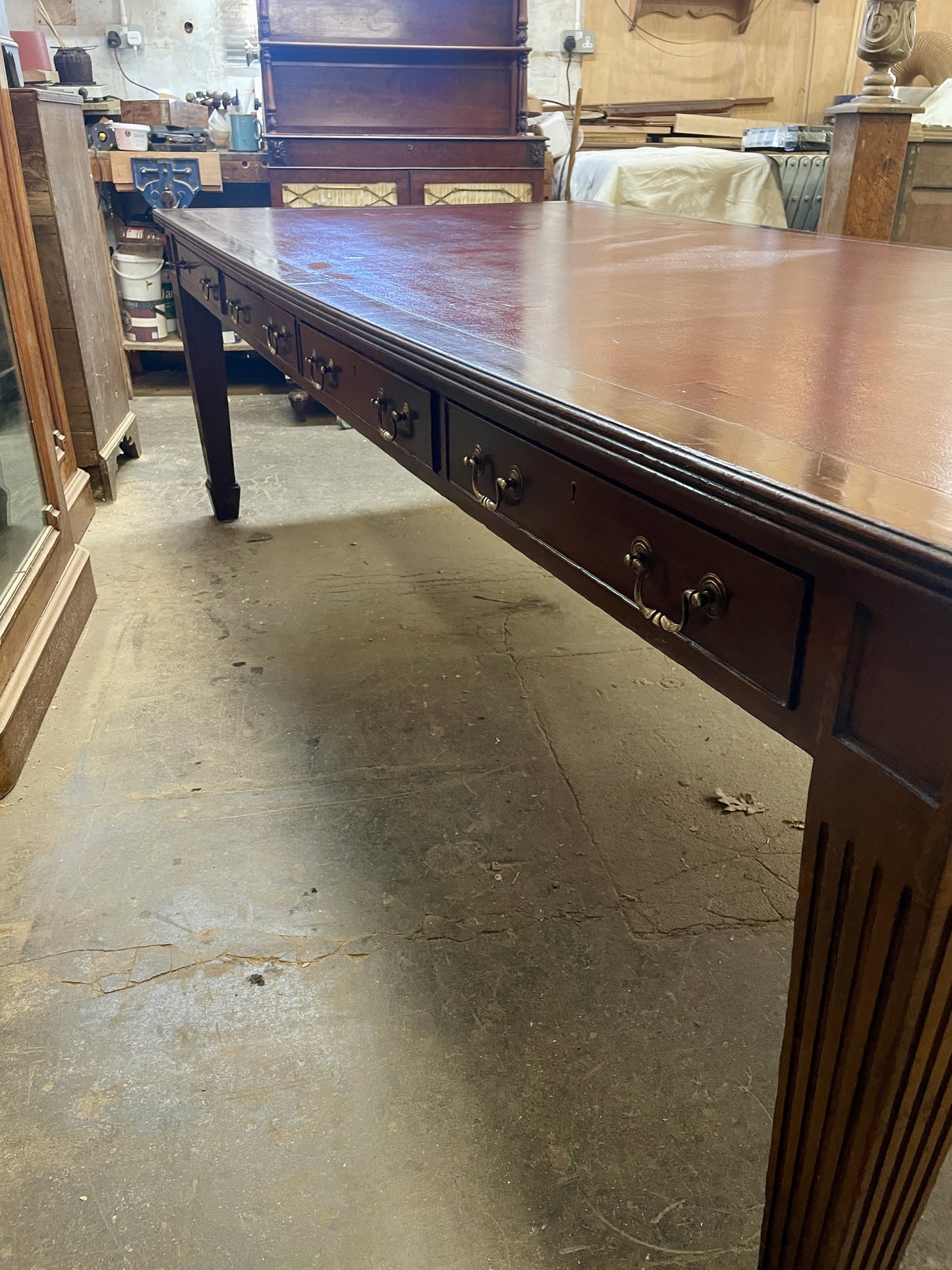 Long wooden table with drawers in a workshop setting