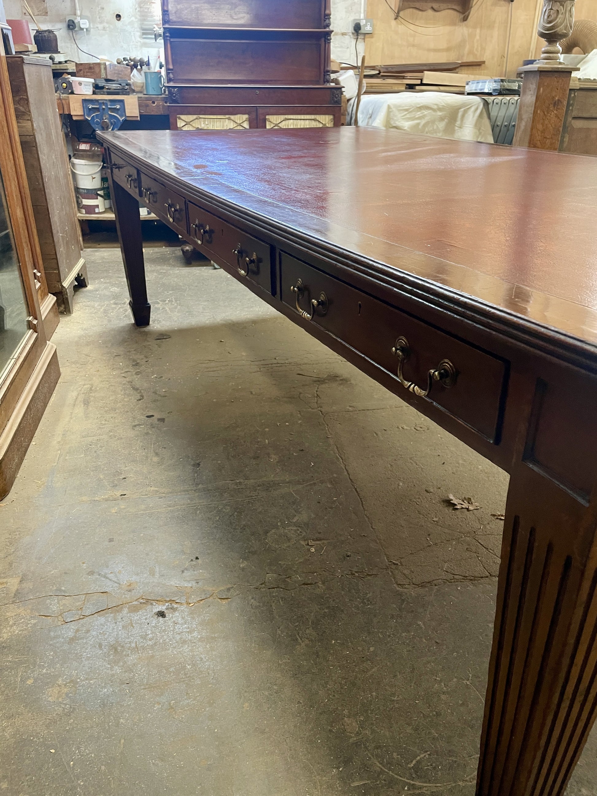 Long wooden table with drawers in a workshop setting