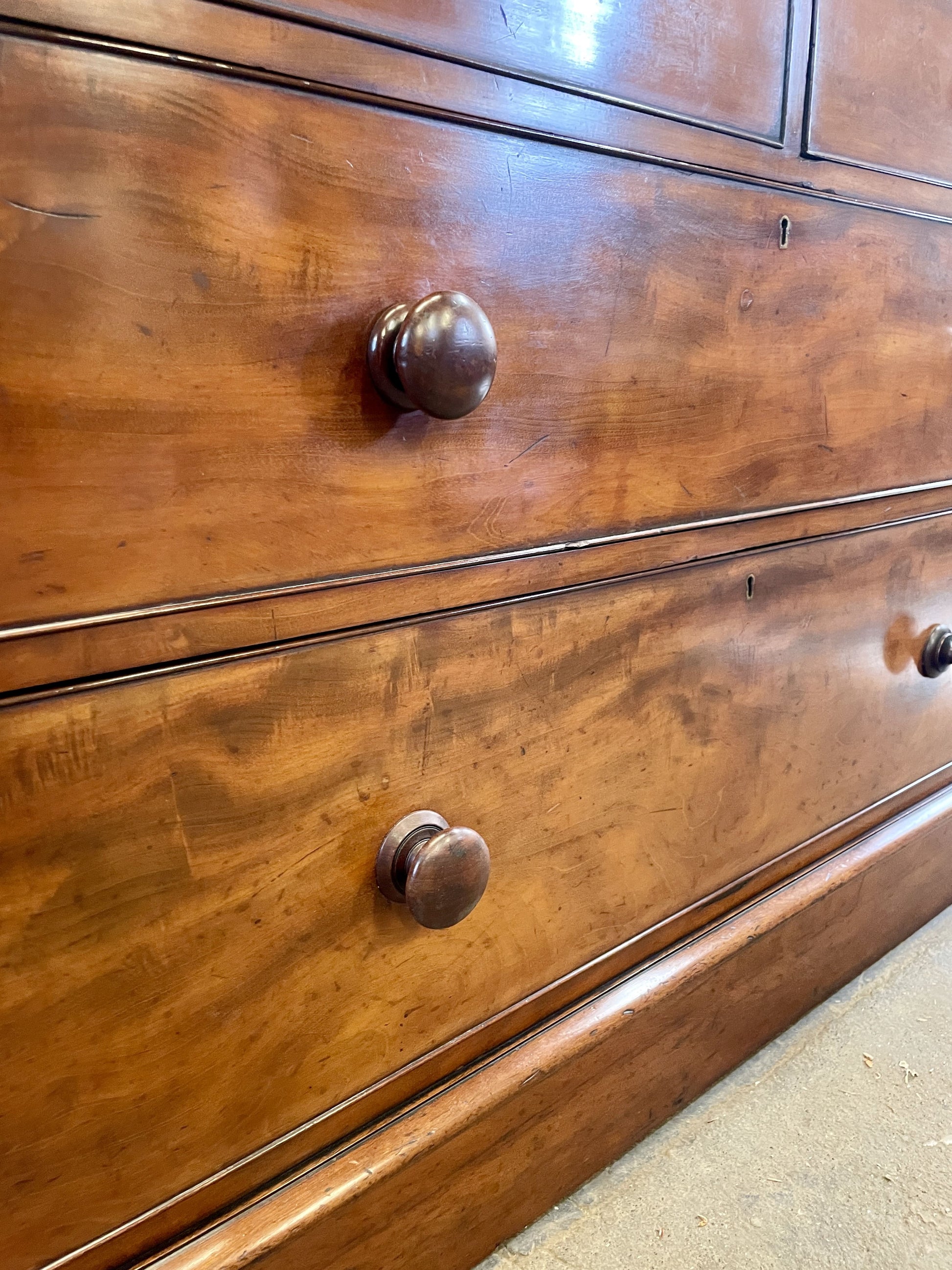 Close-up of a wooden dresser with metal knobs