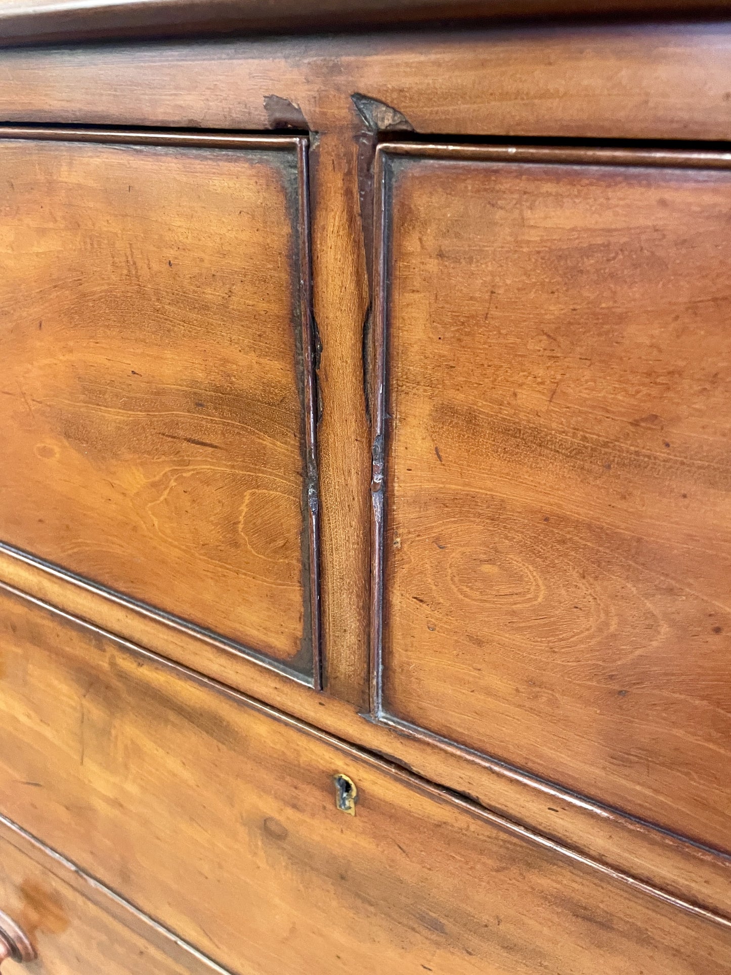 Close-up of a wooden cabinet with visible grain and wear.