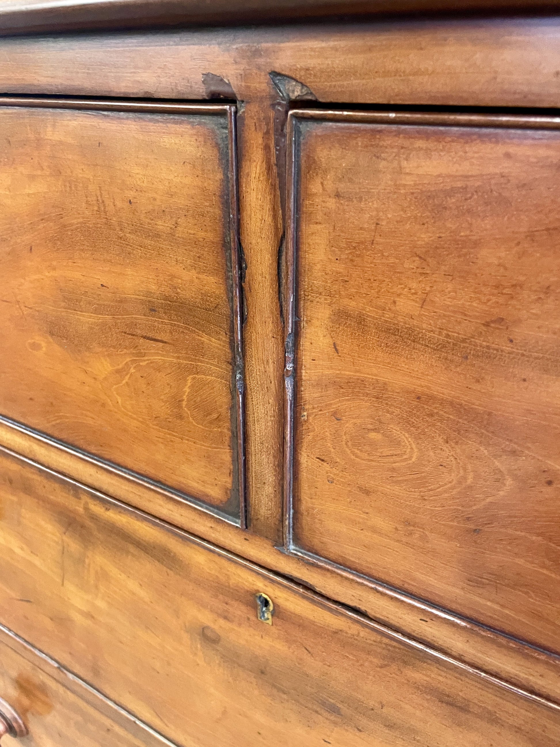 Close-up of a wooden cabinet with visible grain and wear.