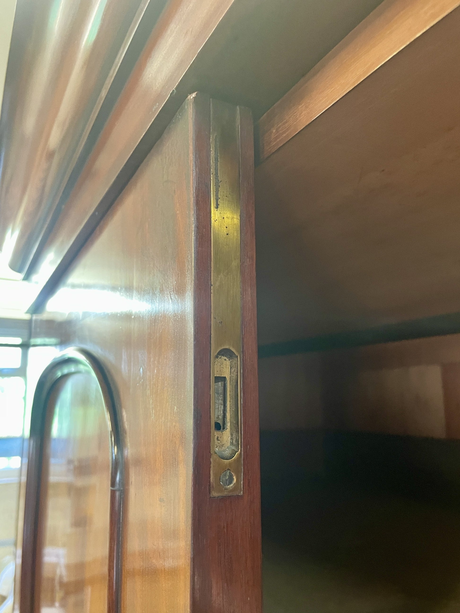 Close-up of a wooden door with a metallic handle and lock
