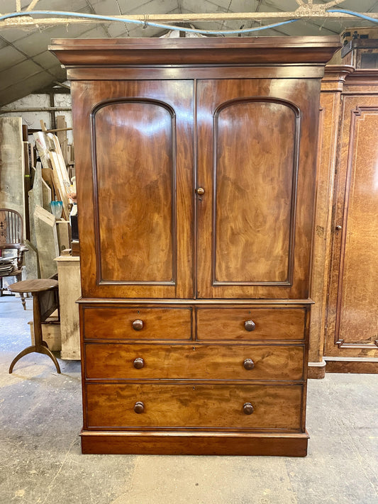 Wooden wardrobe with two doors and three drawers in a workshop setting