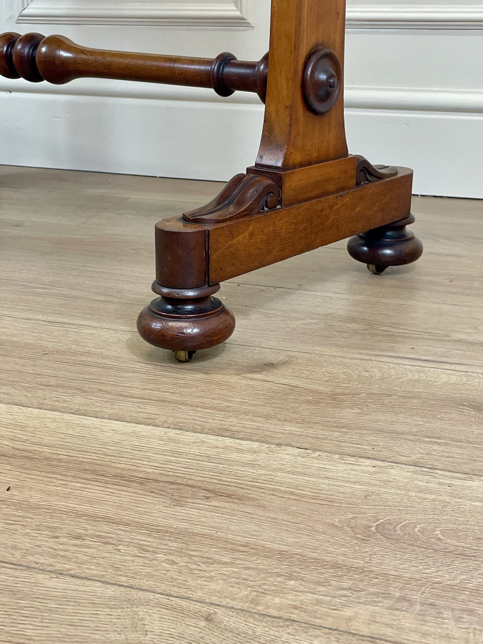Wooden stand with wheels on a wooden floor