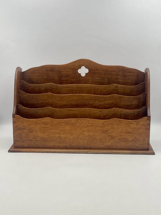 Wooden letter rack with multiple compartments on a white background