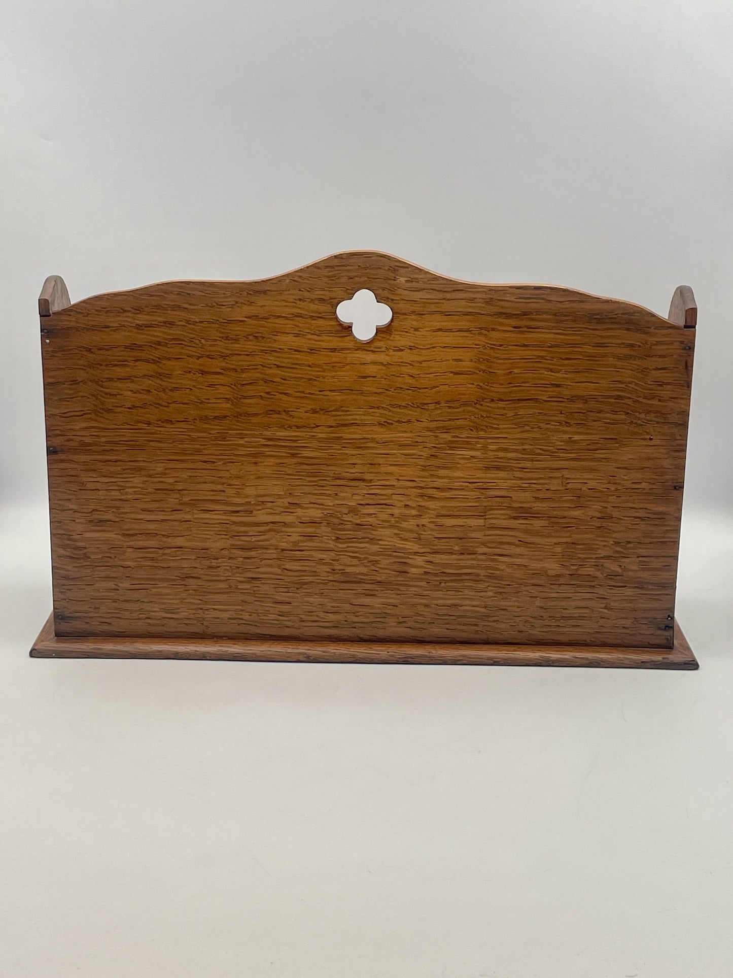Wooden sign with a decorative cutout on a white background