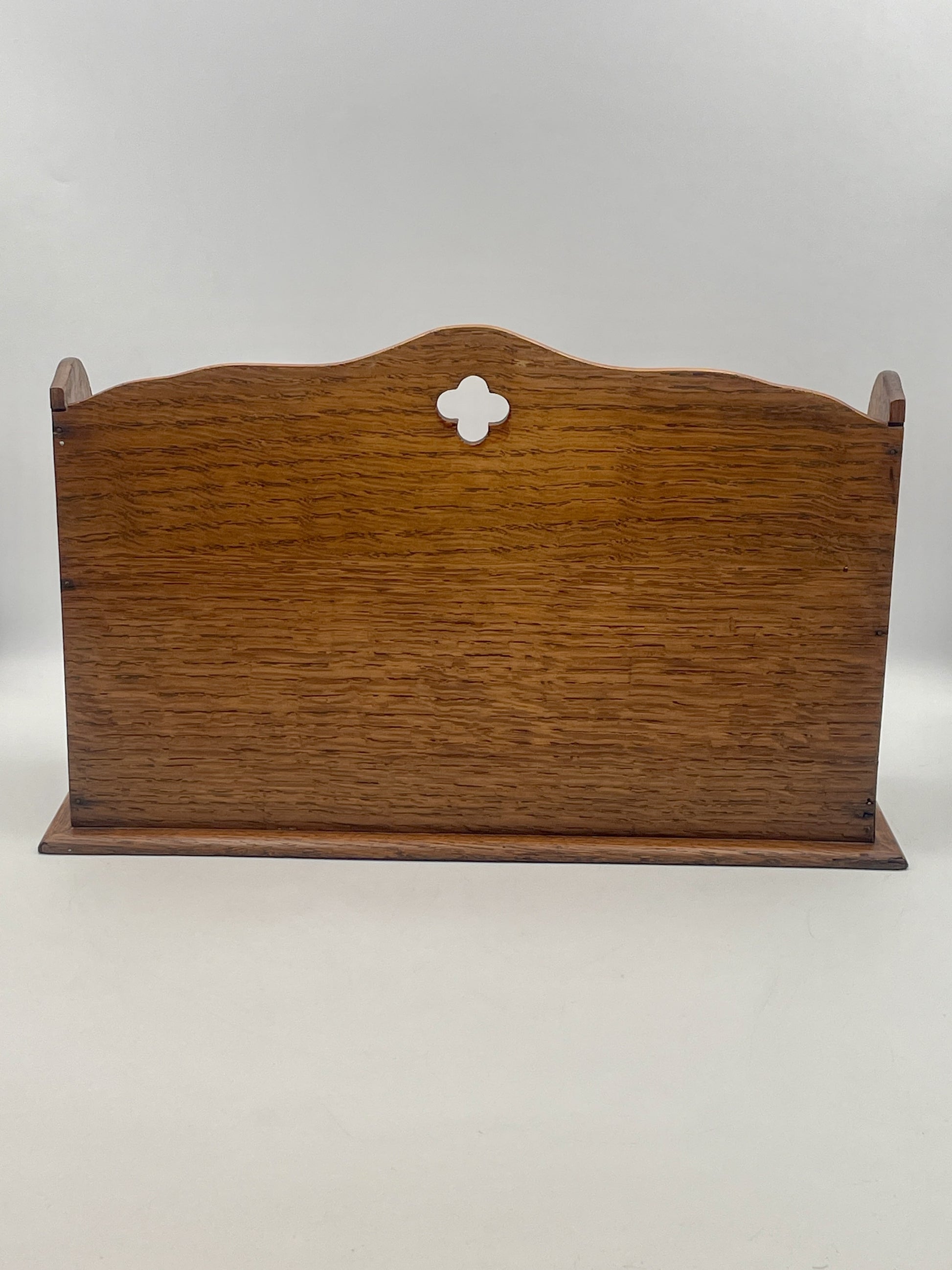 Wooden sign with a decorative cutout on a white background