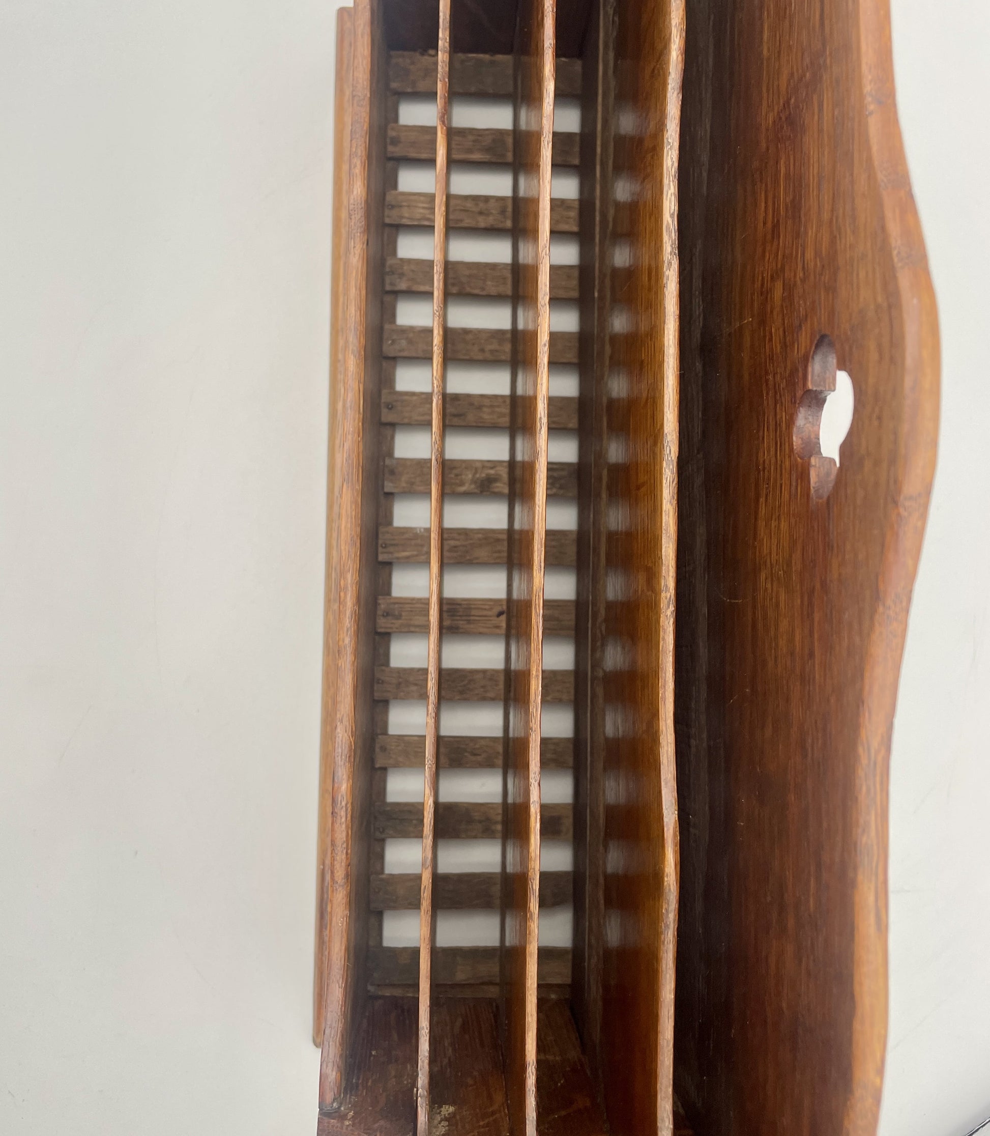 Wooden musical instrument with a slatted design on a white background