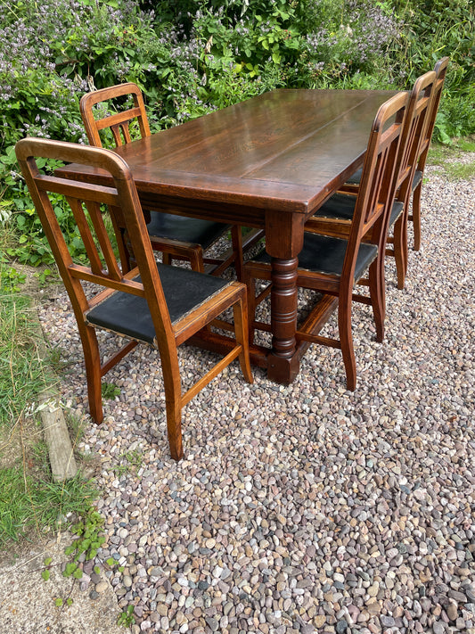 Set of wooden chairs stacked outdoors on a gravel surface