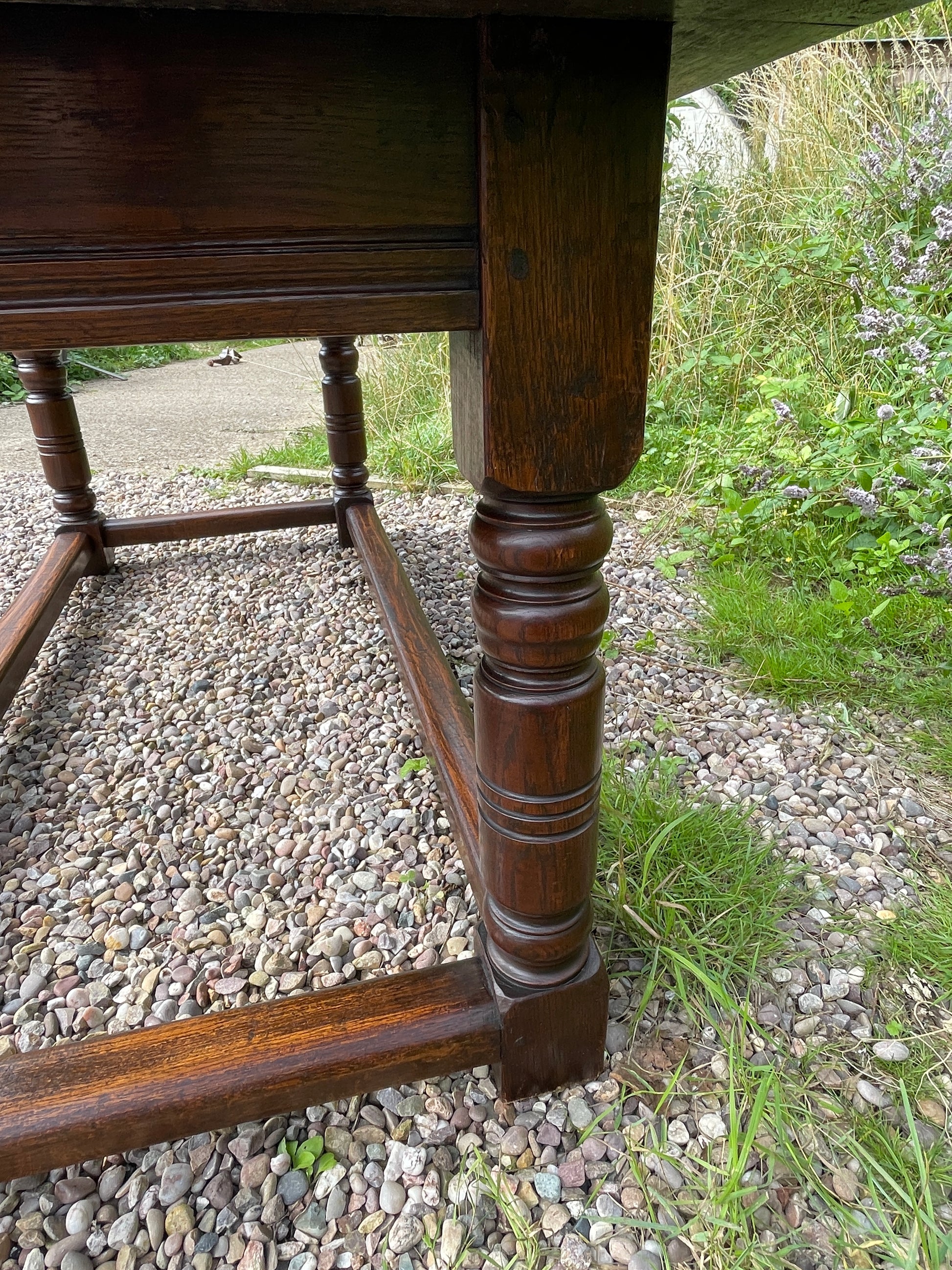 Wooden table backrest on a gravel and grass background