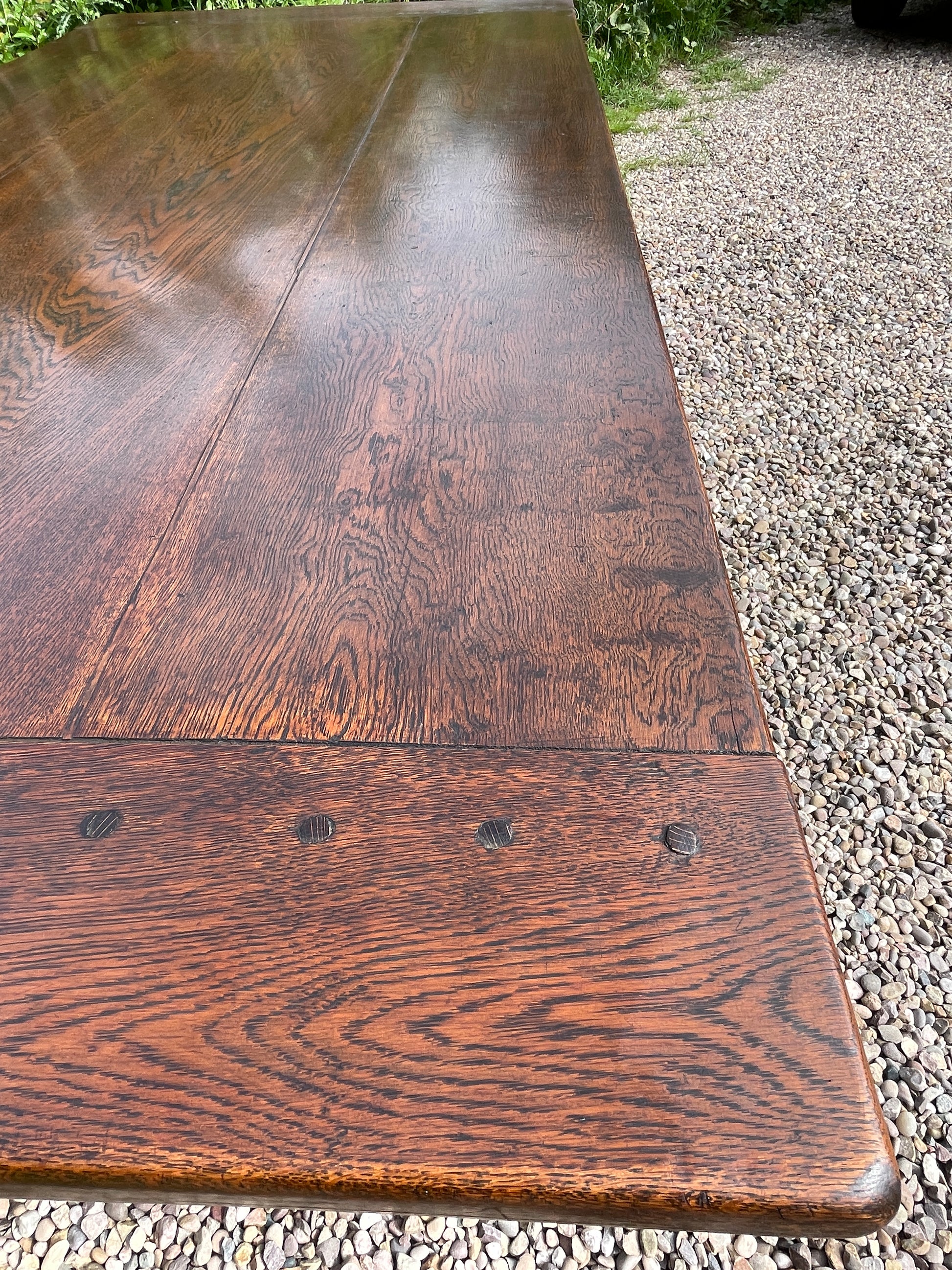 Wooden bench with a worn surface on a gravelly ground