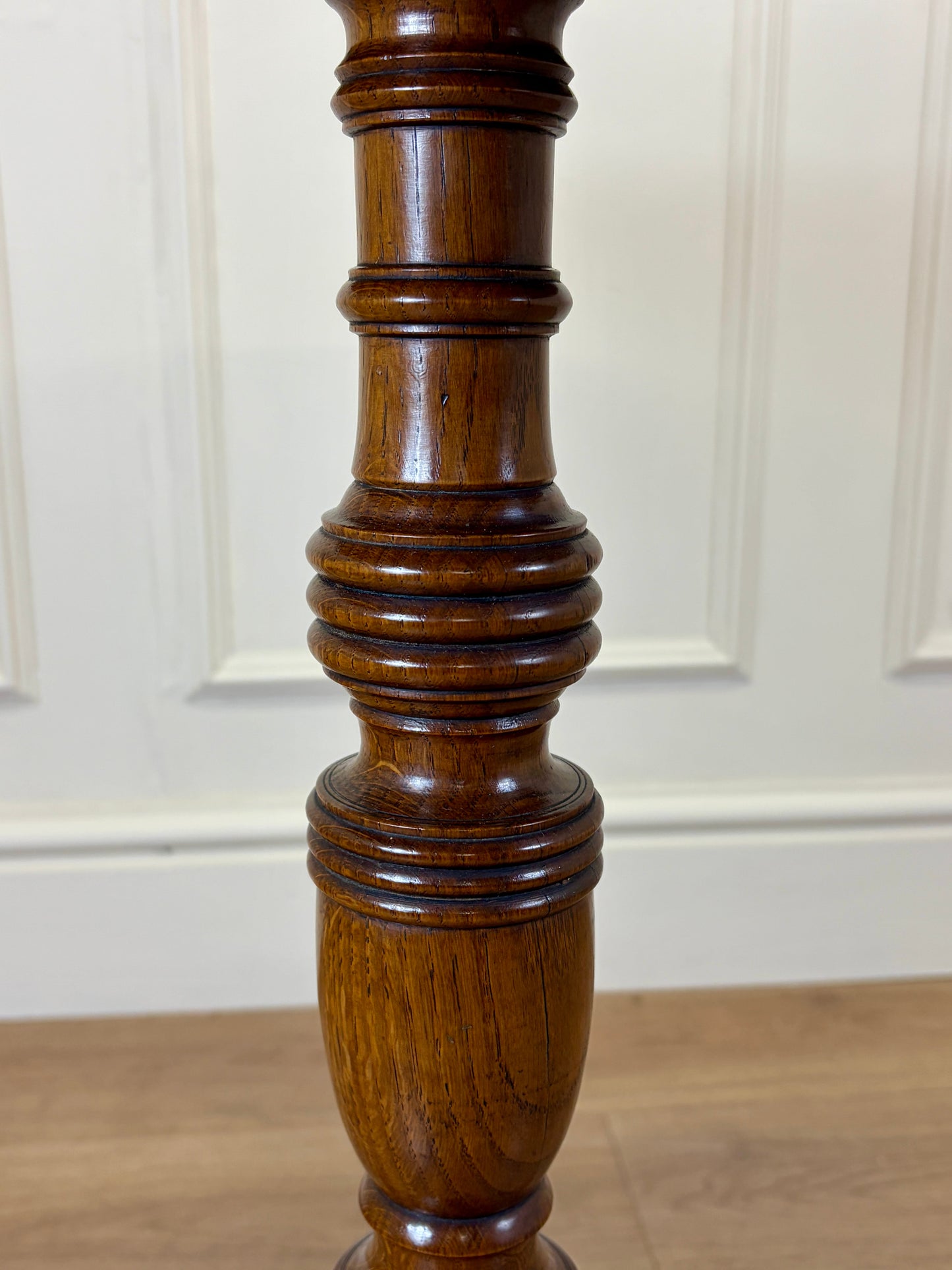 Antique Georgian oak tripod tilt-top table with oval top and tripod base in light oak finish.