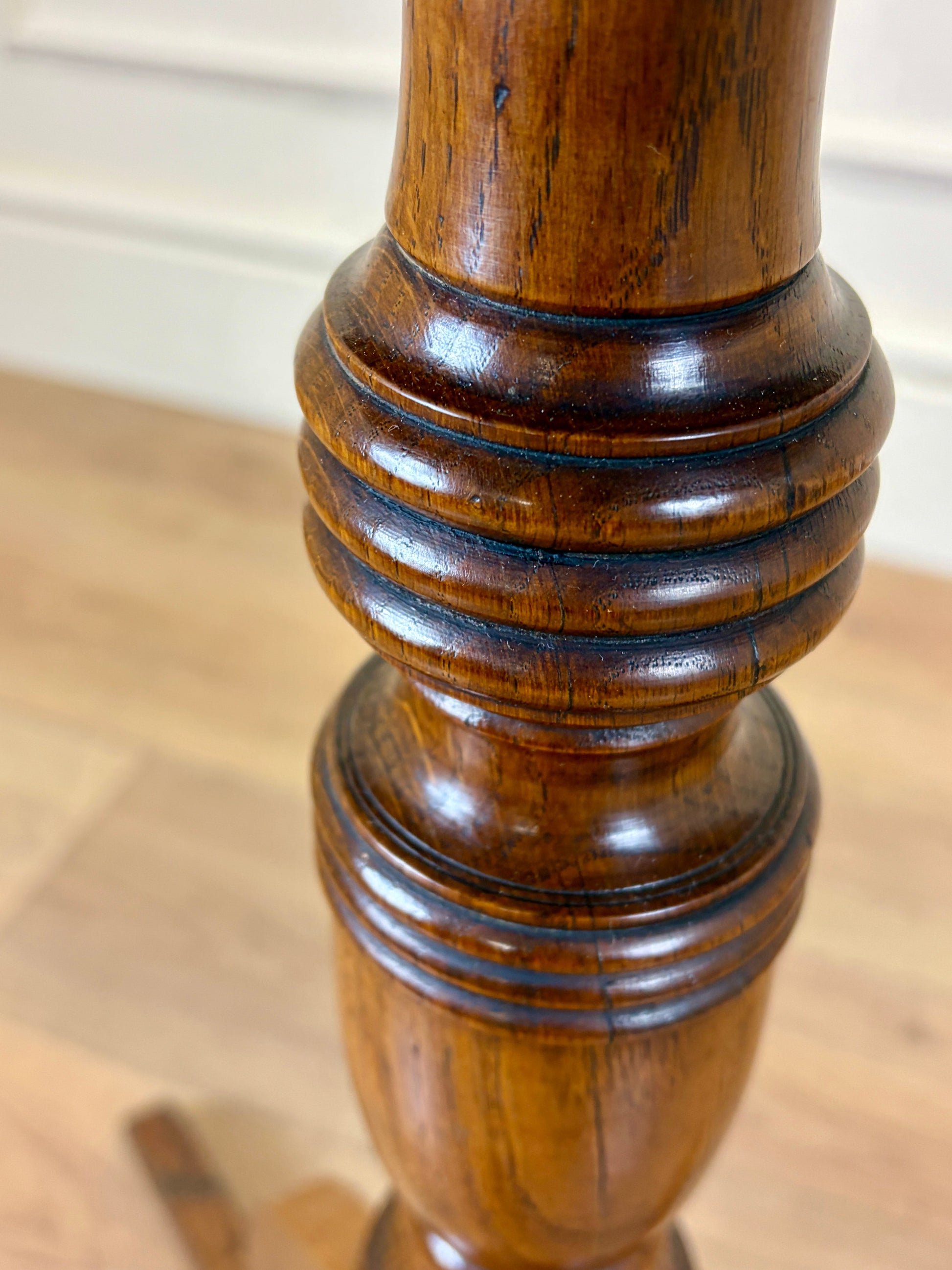 Antique Georgian oak tripod tilt-top table with oval top and tripod base in light oak finish.