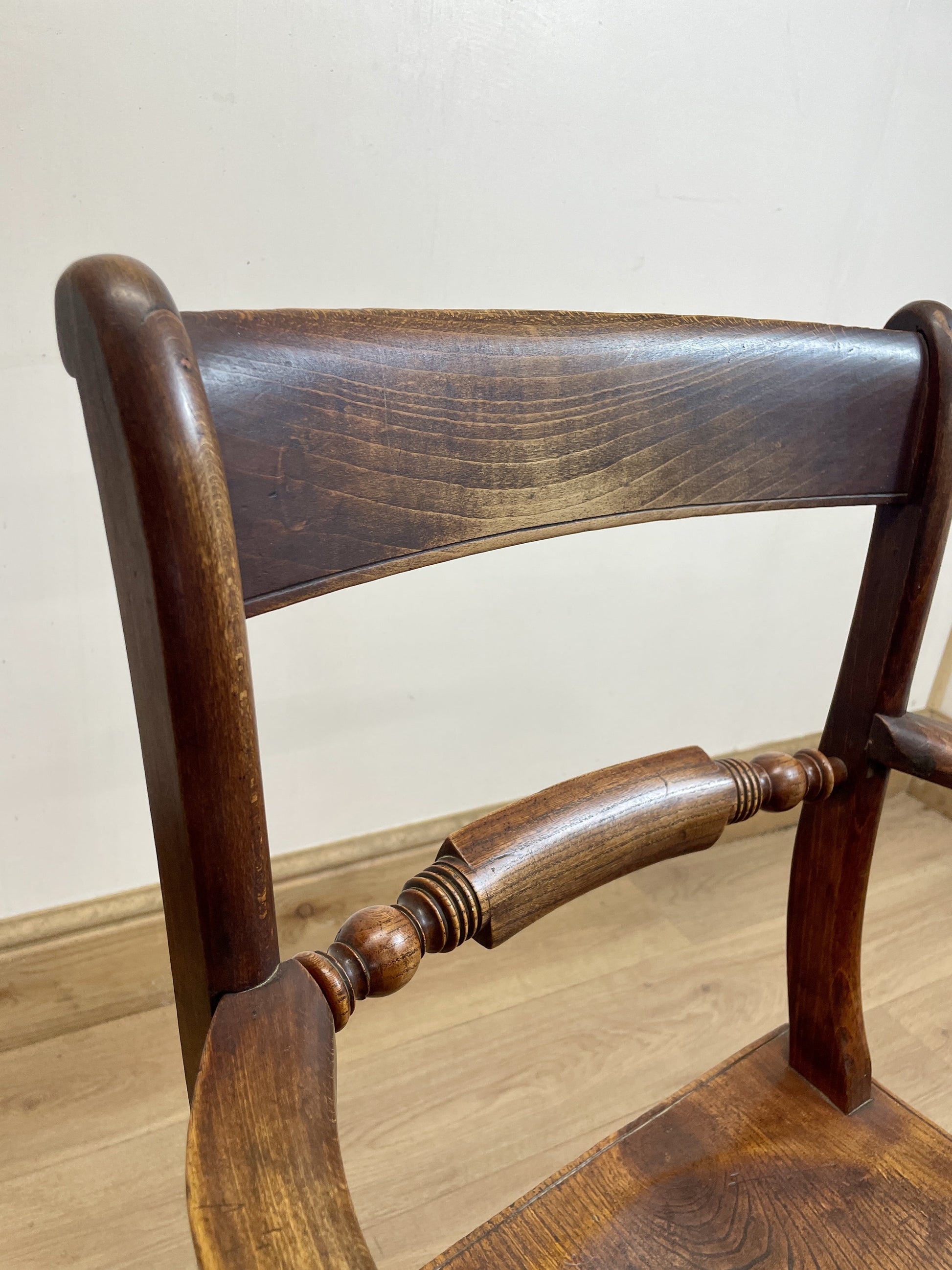 Close-up of a wooden chair with a plain background