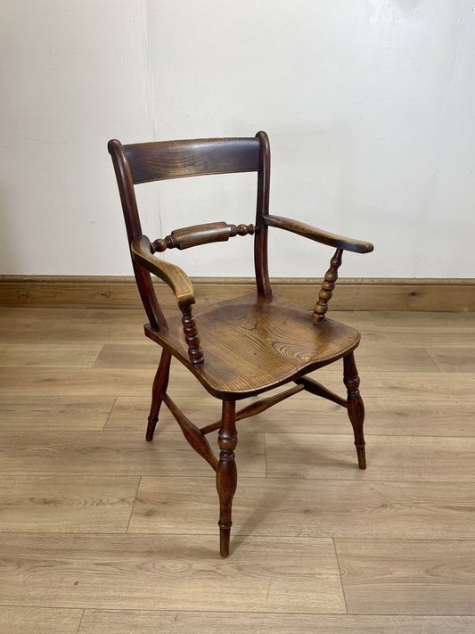 Wooden chair on a wooden floor with a white wall background