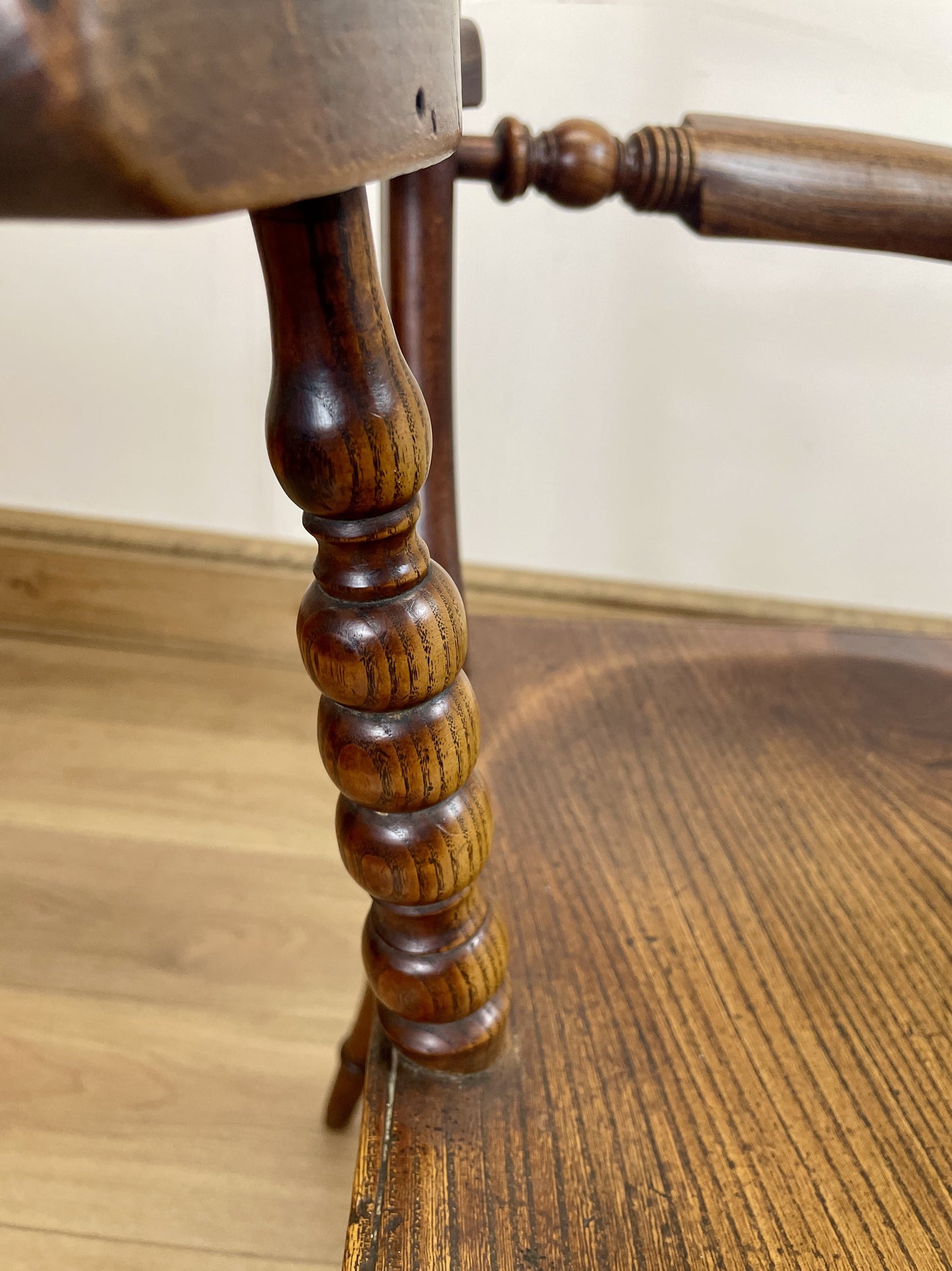 Close-up of a wooden chair leg on a table with a blurred background