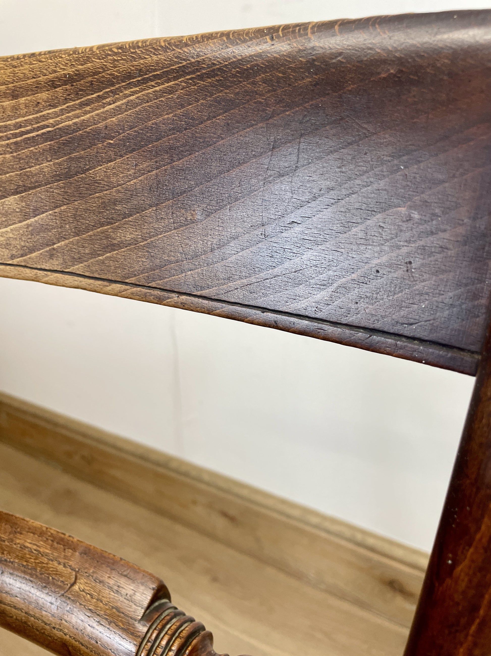 Close-up of a wooden chair with a focus on the seat and backrest.