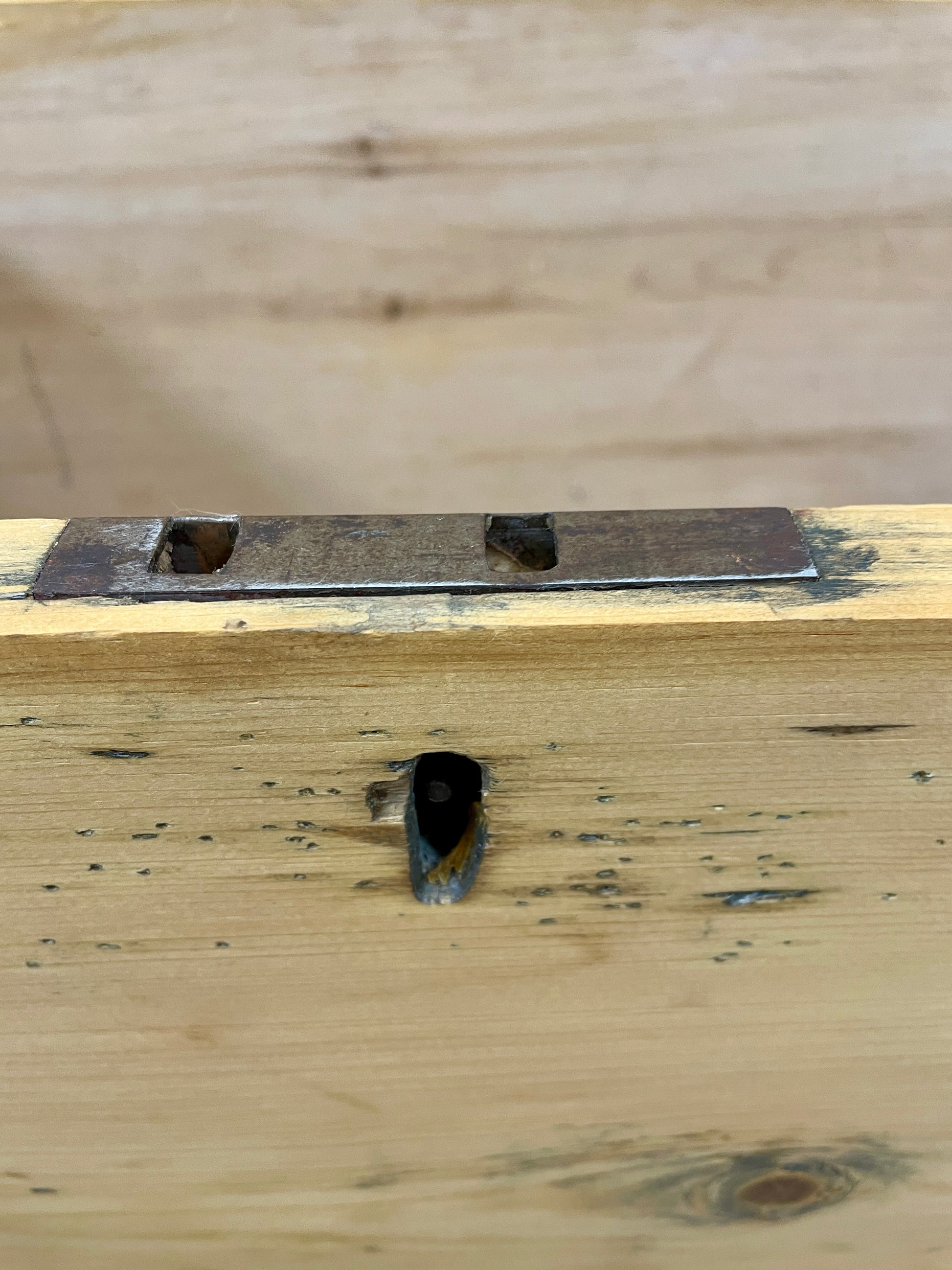 Wooden surface with a metal bracket attached