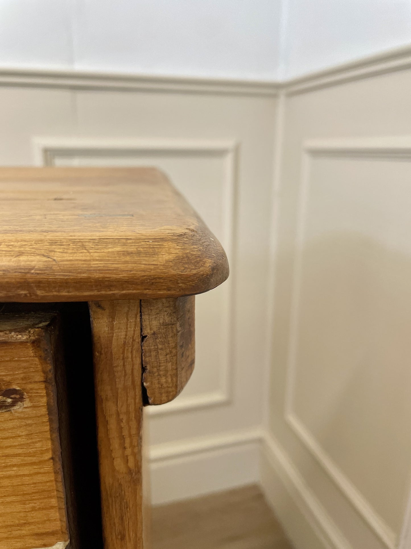 Wooden drawers against a white paneled wall