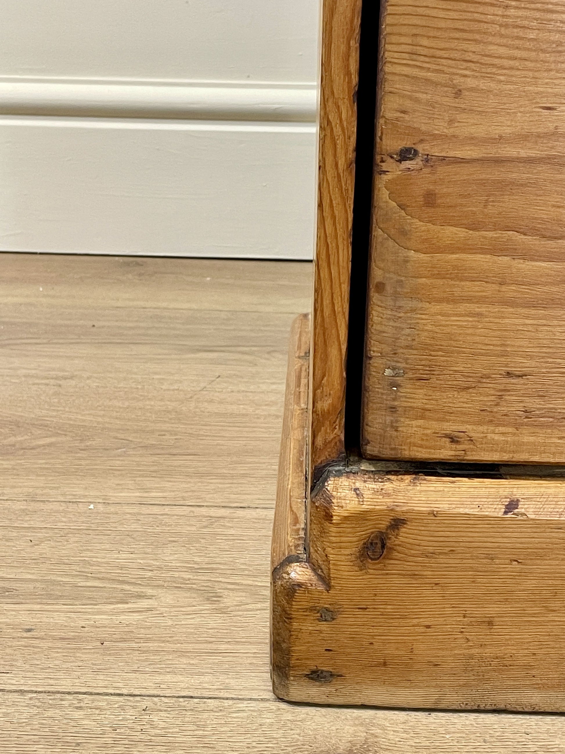 Close-up of a wooden door frame with a gap between two wooden panels.