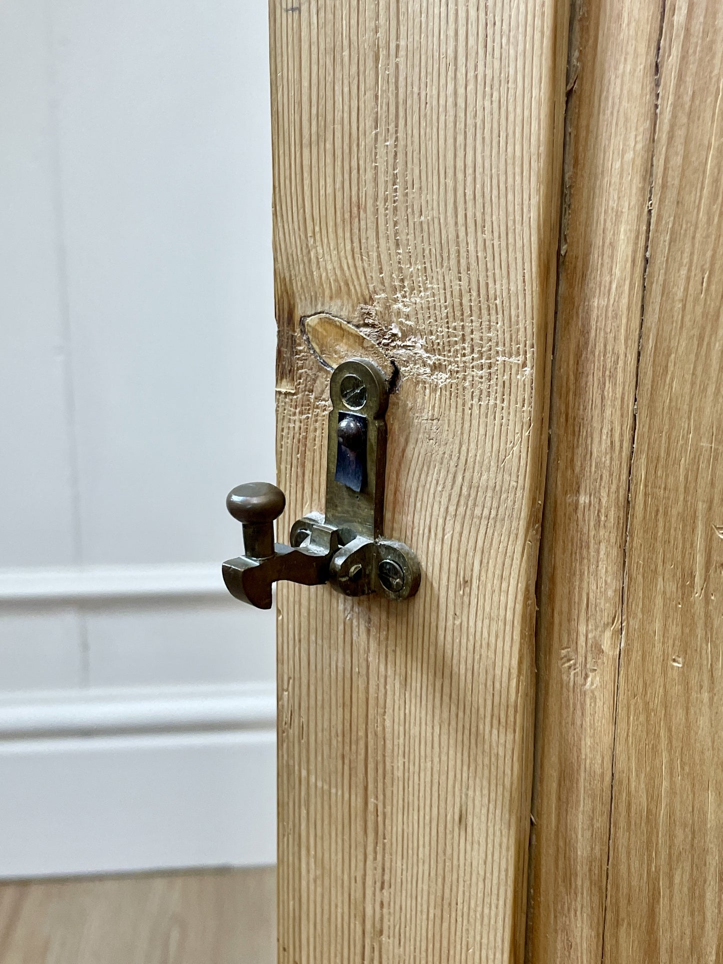 Wooden door with a metal latch on a white background