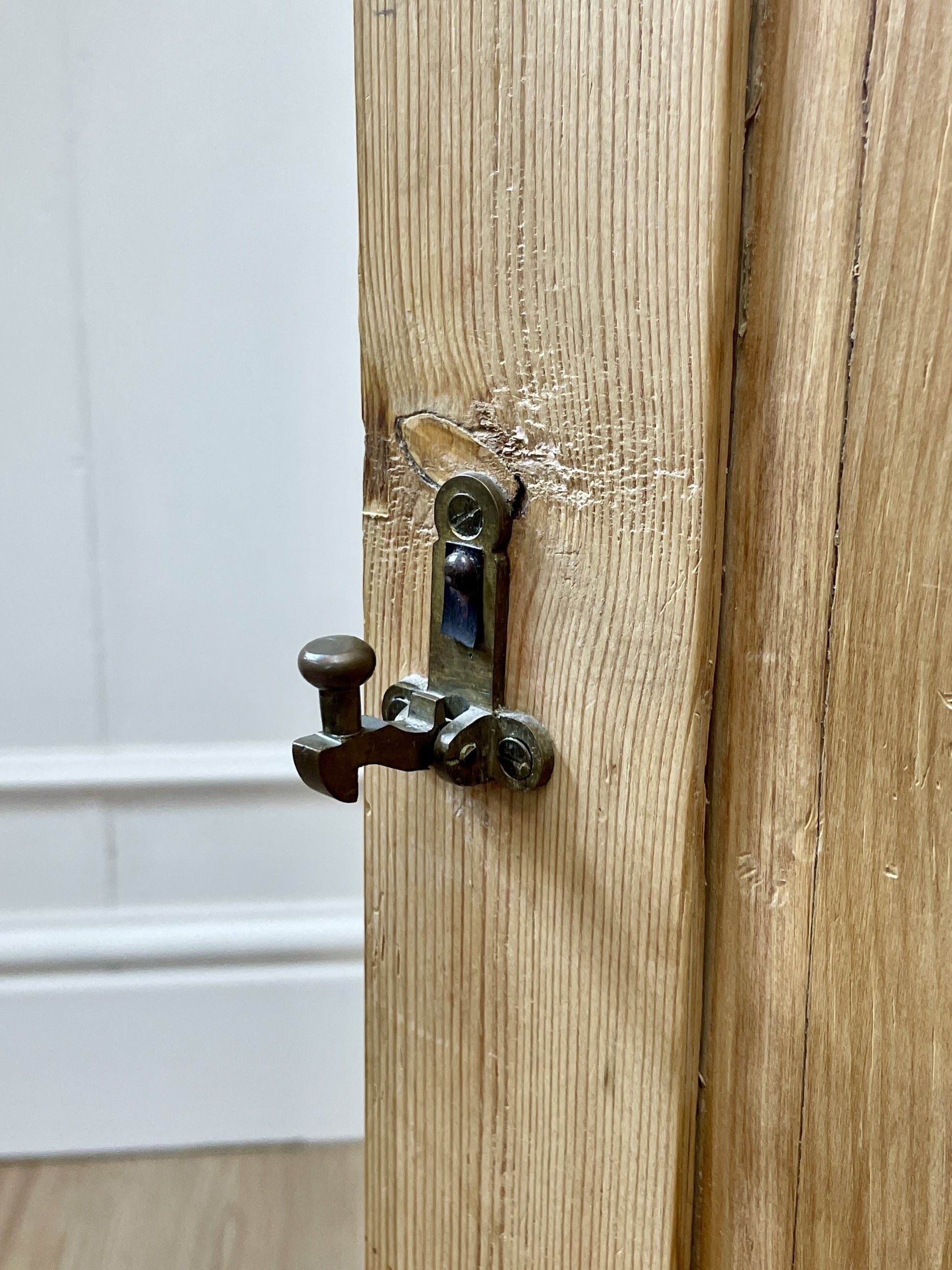 Wooden door with a metal latch on a white background