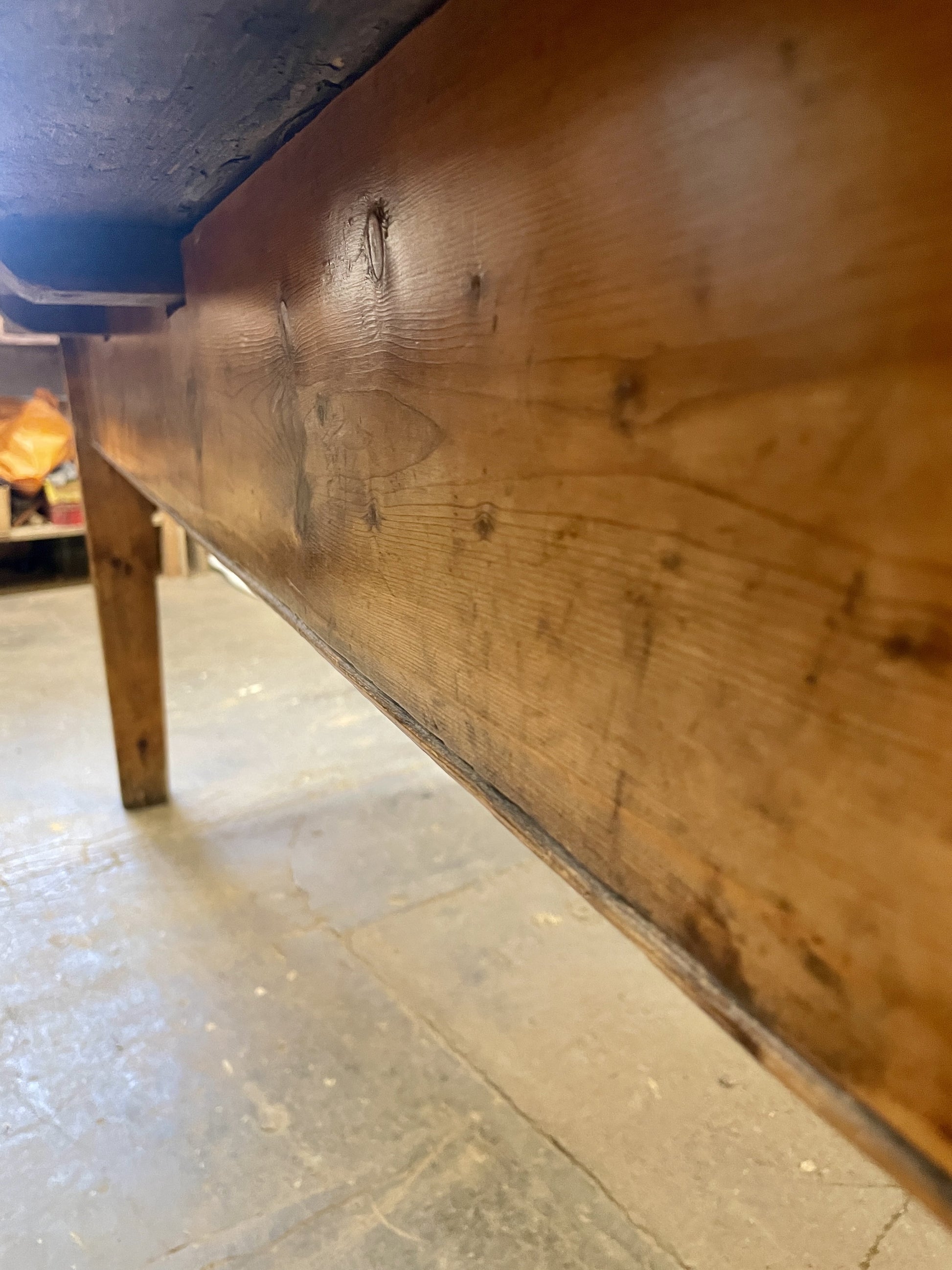 Wooden surface with a blue edge on a tiled floor
