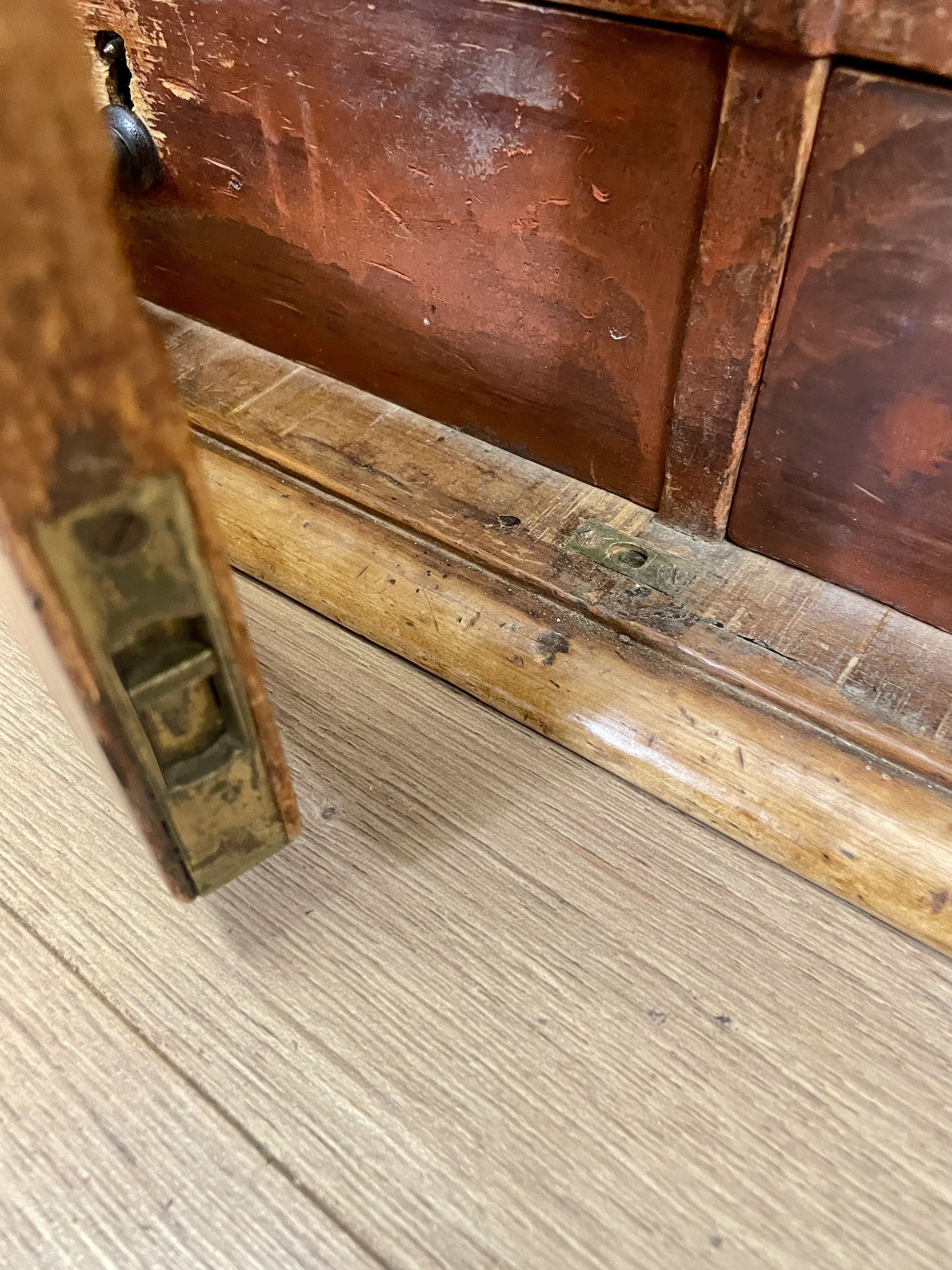 Close-up of a wooden surface with a metal latch
