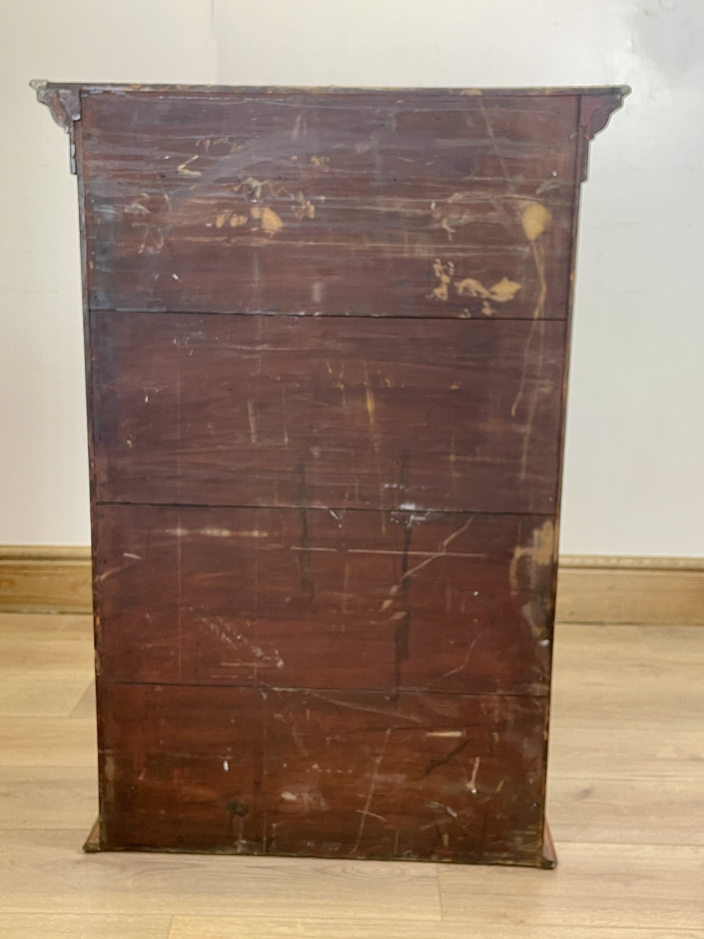 Vintage wooden dresser with visible wear on a plain background