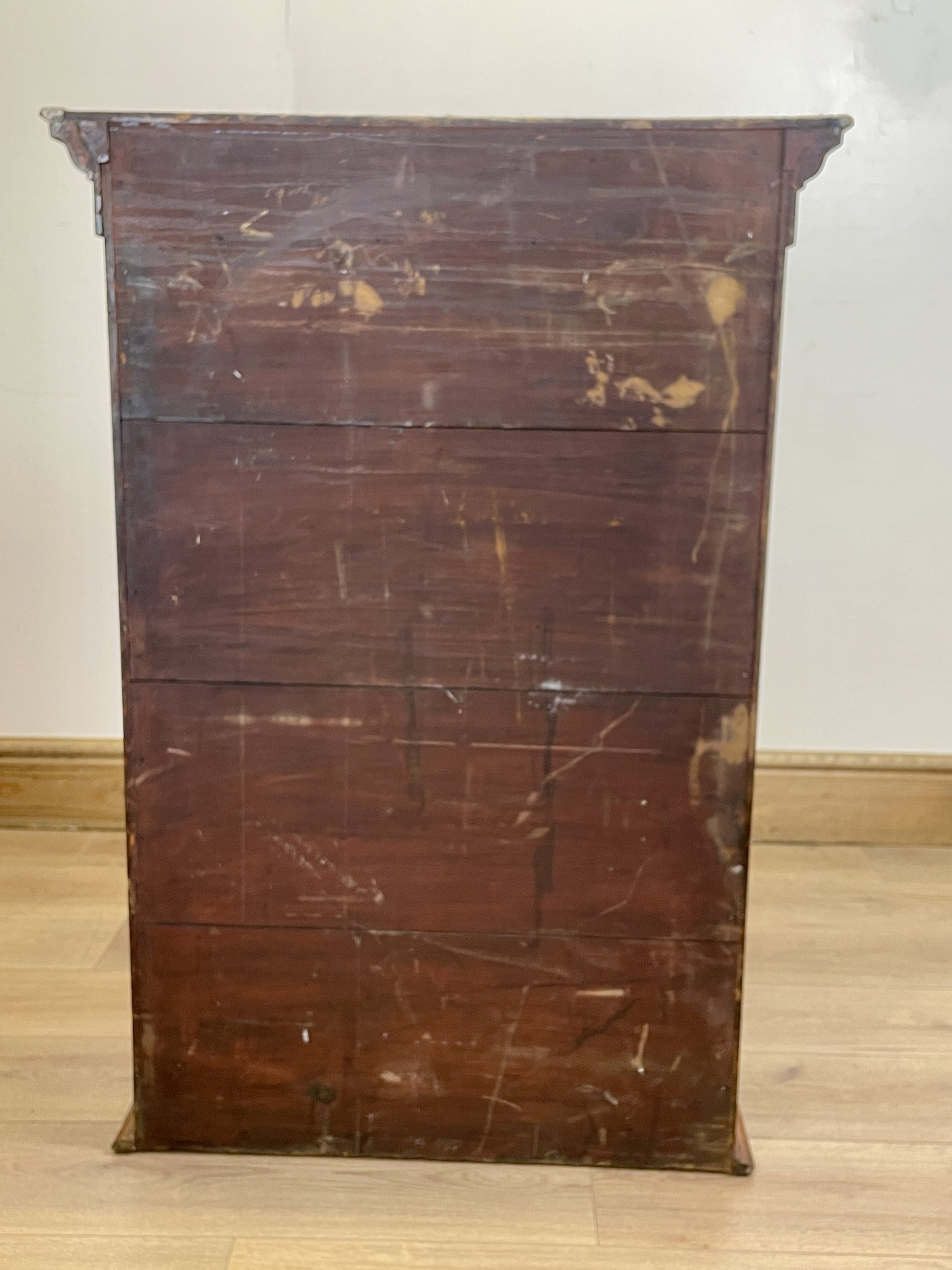 Vintage wooden dresser with visible wear on a plain background