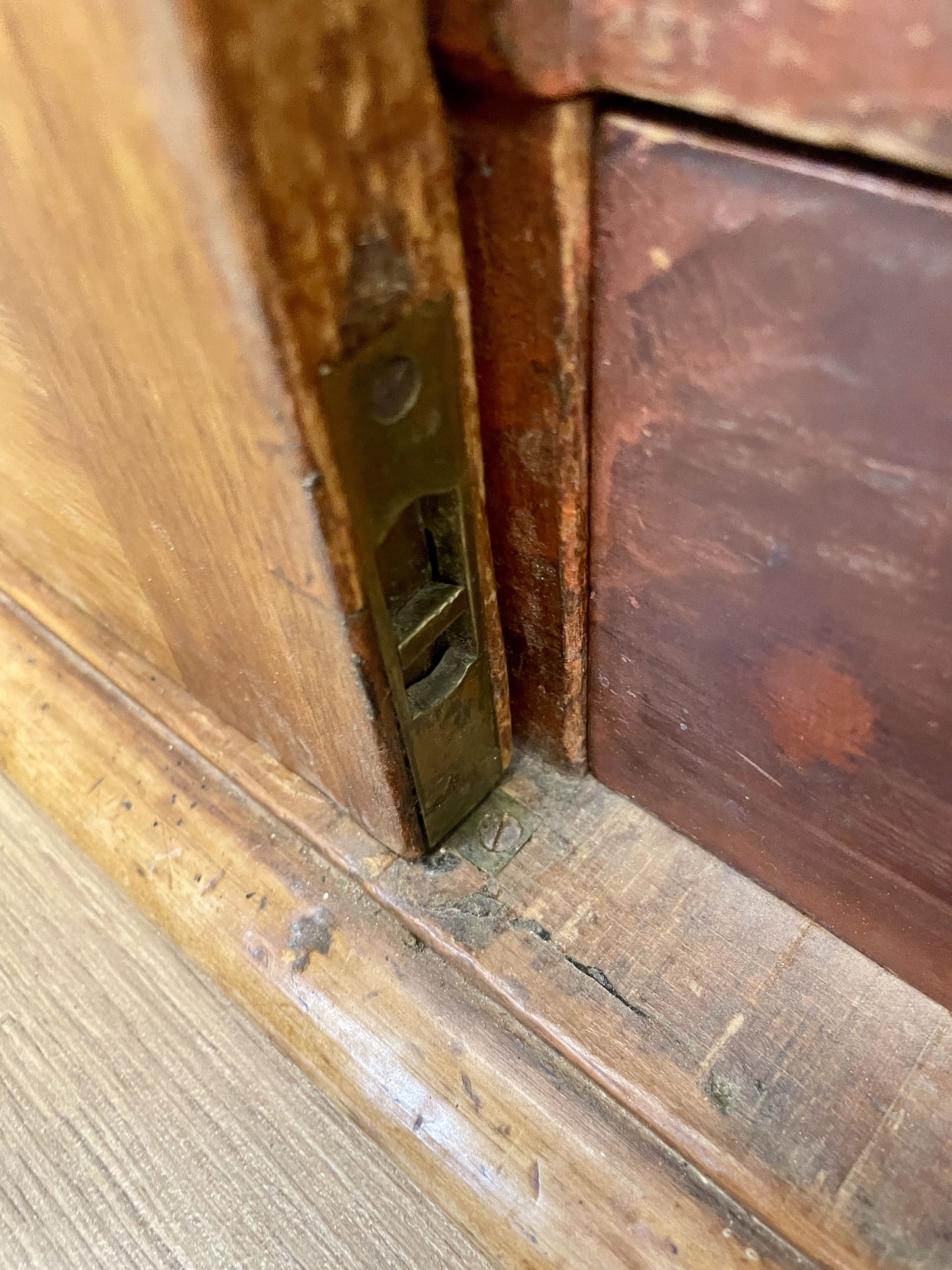 Close-up of a wooden door with a brass latch