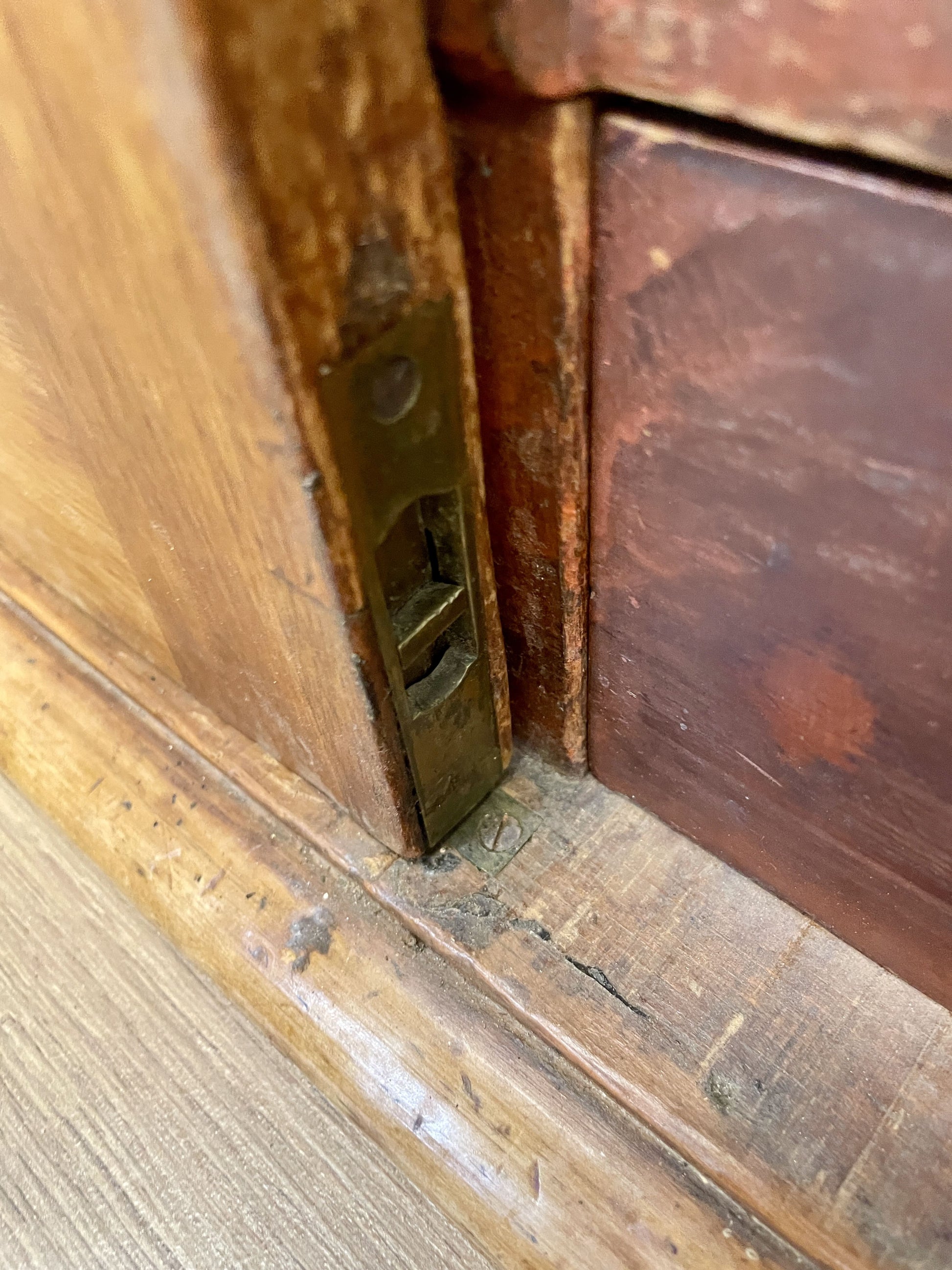 Close-up of a wooden door with a brass latch