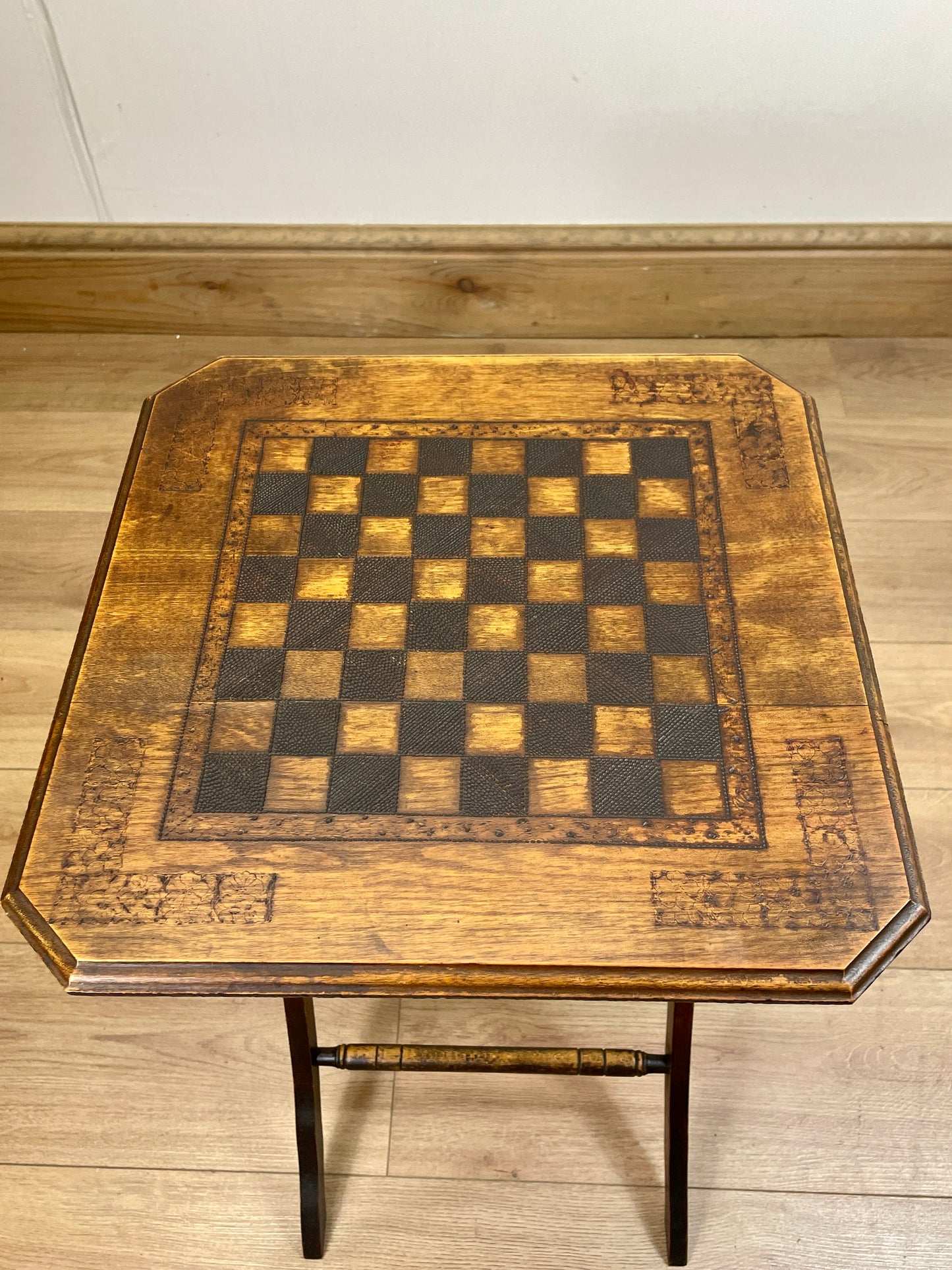 Wooden table with a checkered surface on a wooden floor