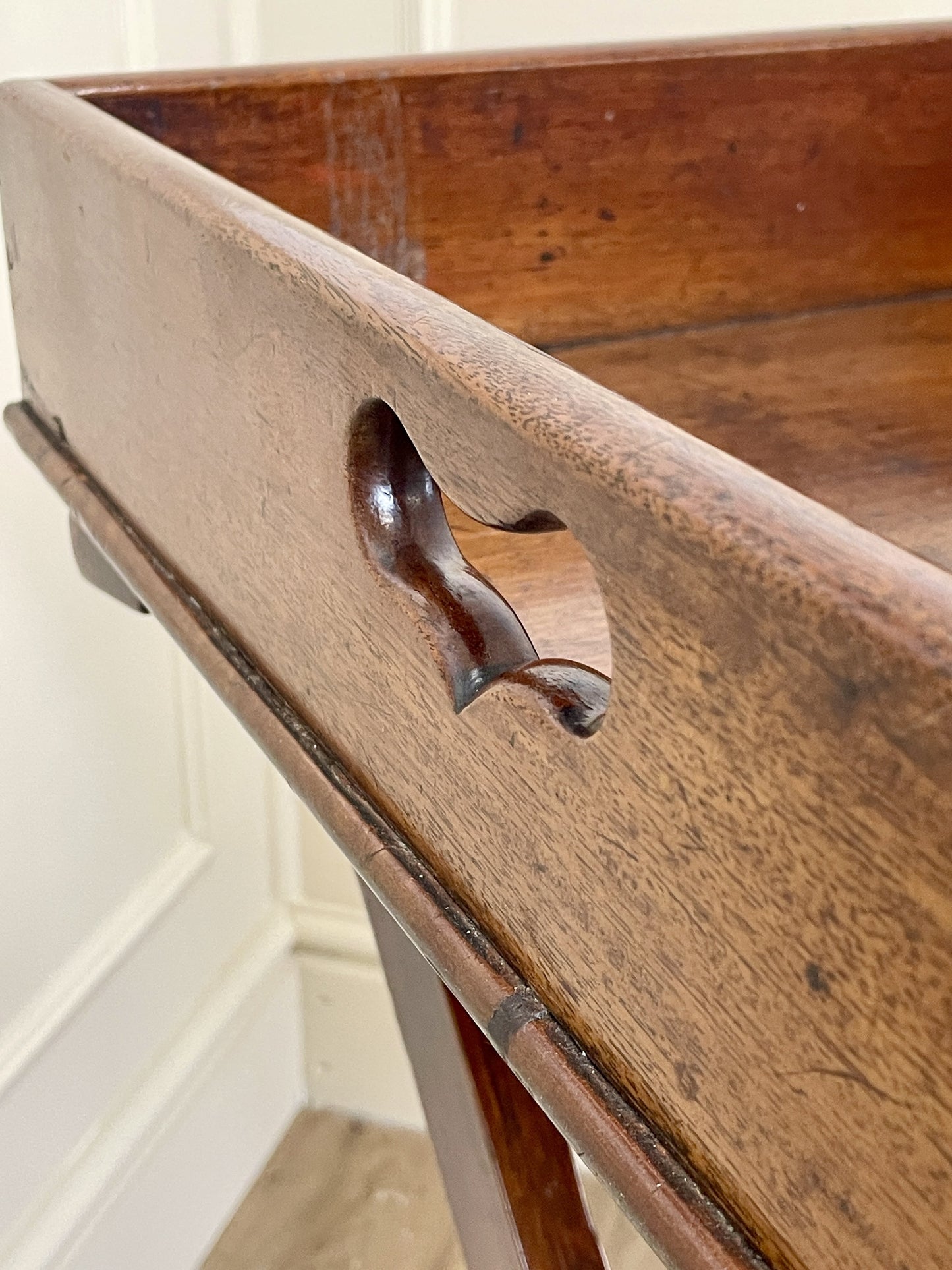 Wooden tray with decorative handle on a white background