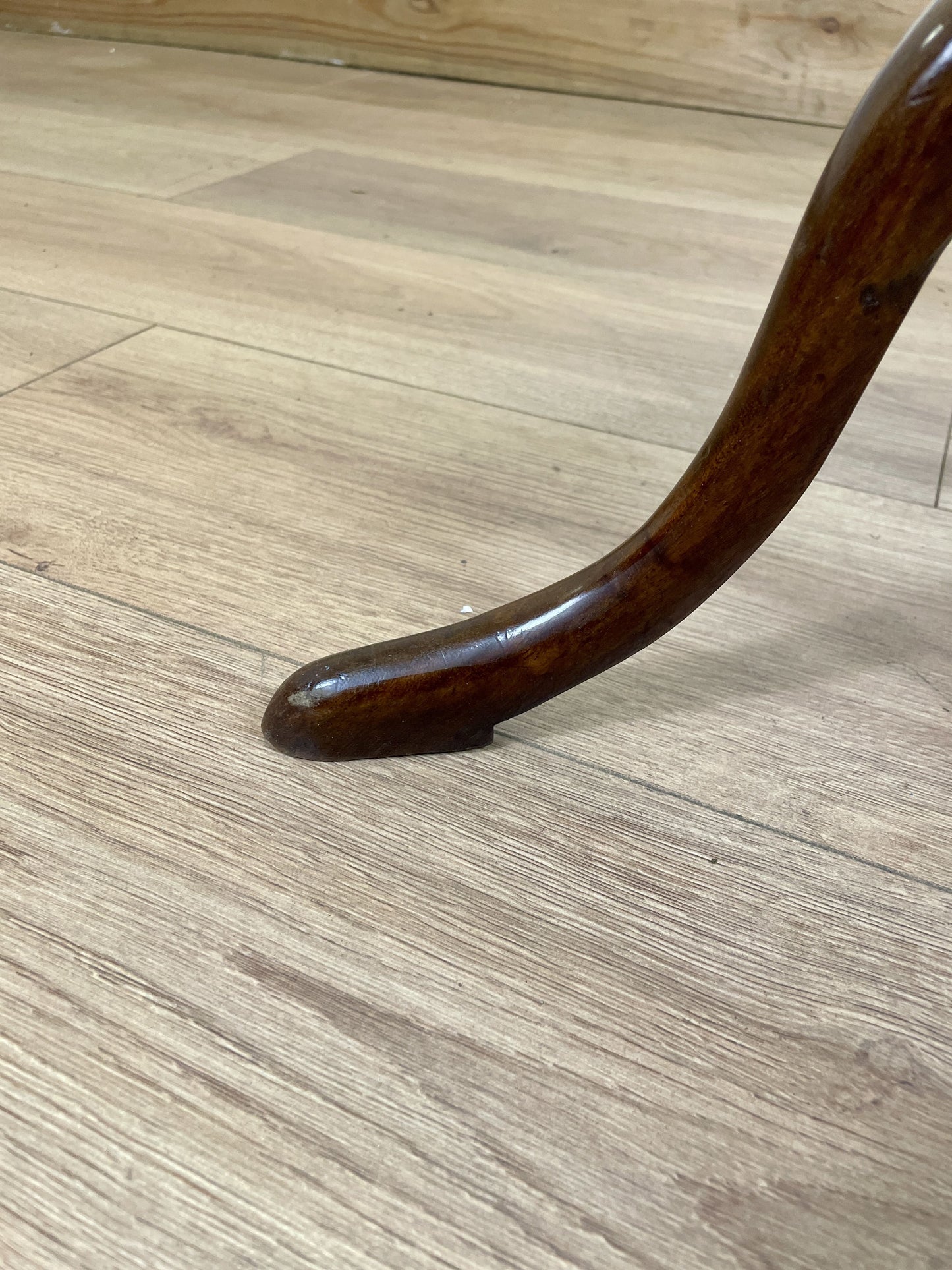Wooden chair leg on a wooden floor