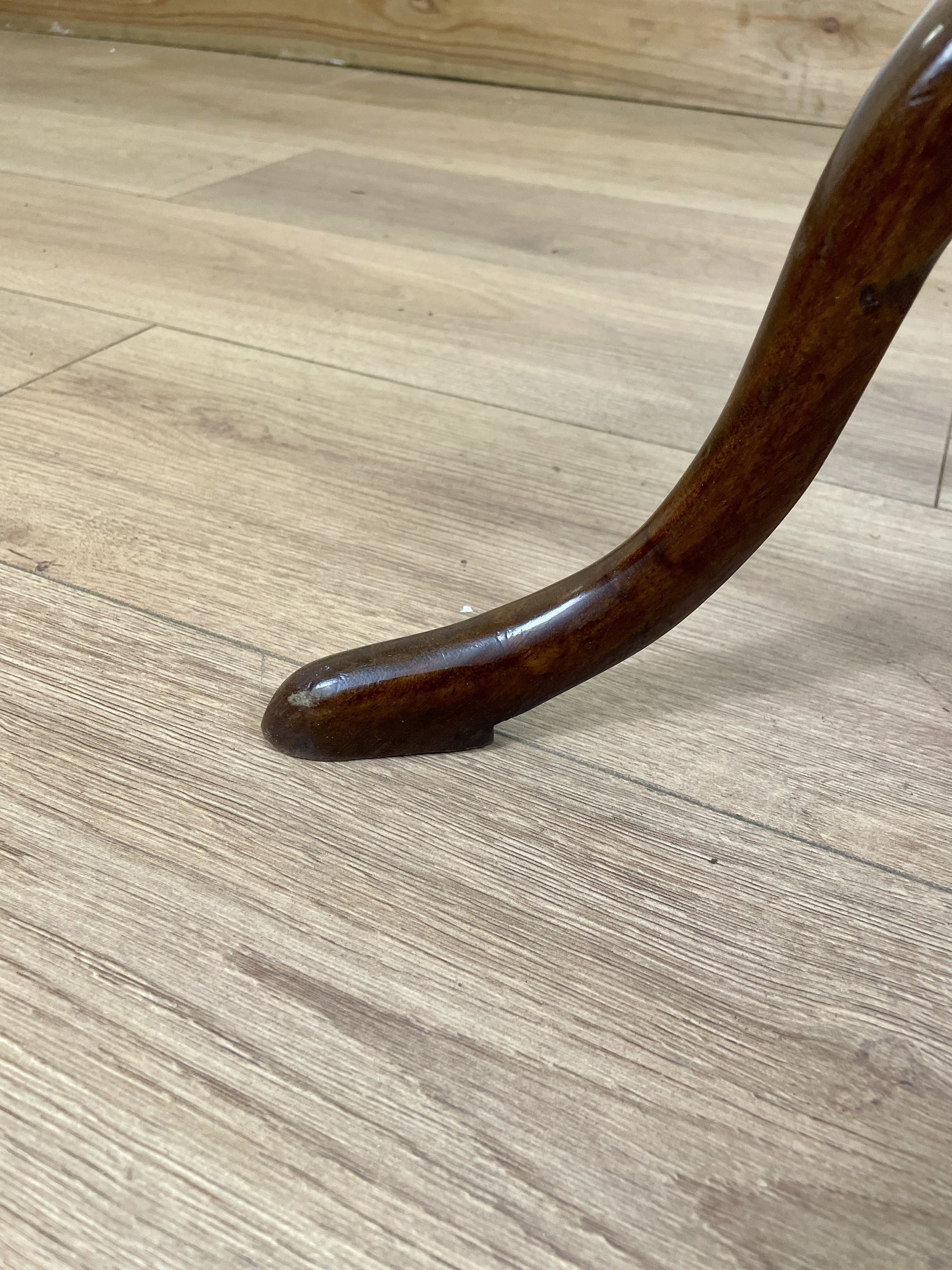 Wooden chair leg on a wooden floor