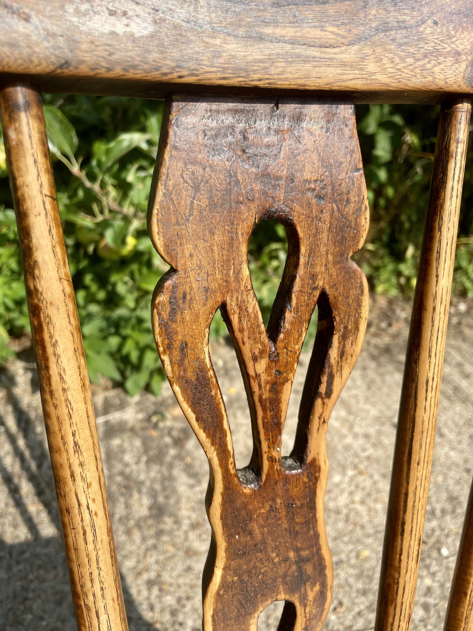 Close-up of a wooden chair with intricate carvings on a natural background